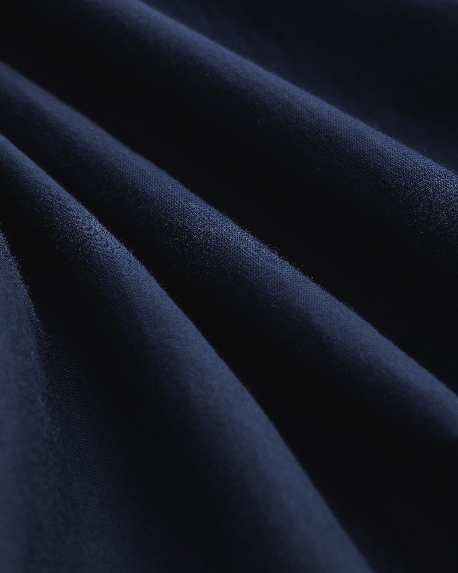 Close-up of Multi-Color T-Shirt 3-Pack fabric, showing soft folds, smooth texture, and gentle shadows.