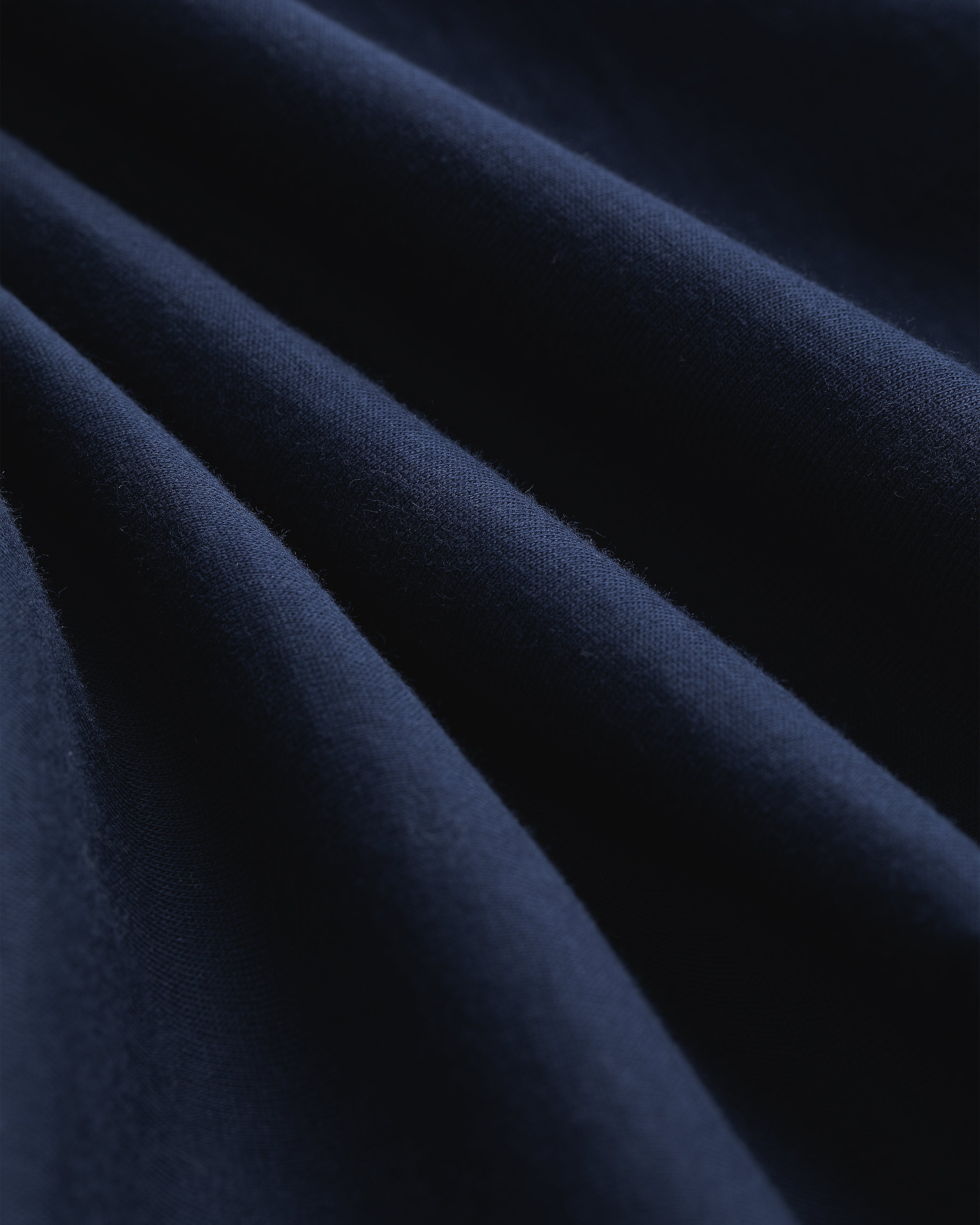 Close-up of Multi-Color T-Shirt 3-Pack fabric, showing soft folds, smooth texture, and gentle shadows.