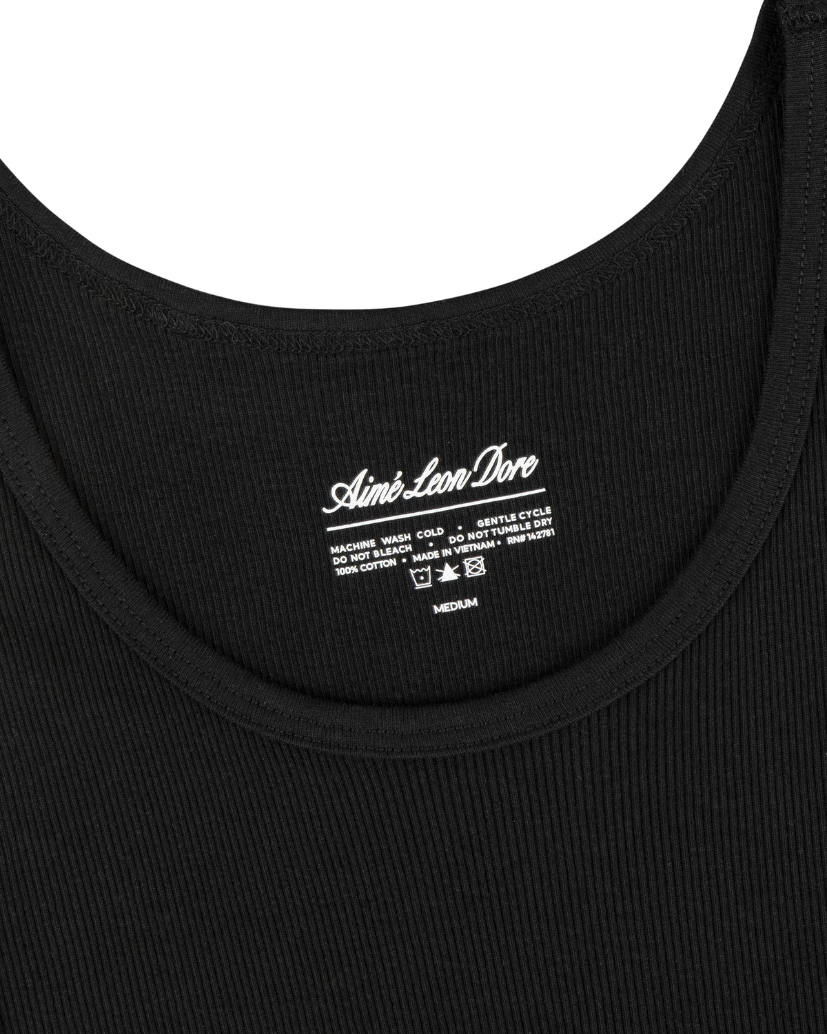 Close-up of a black Tank Top 3-Pack with Aimé Leon Dore logo and care instructions printed at the neckline.
