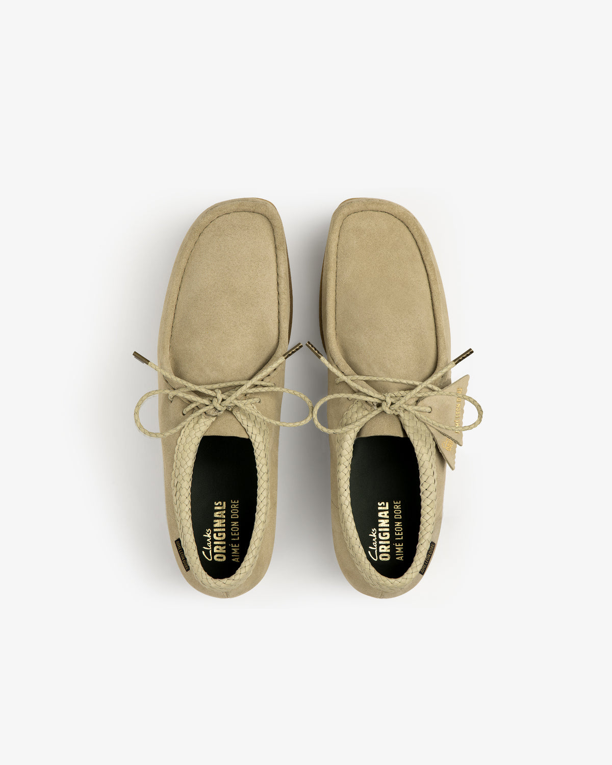 ALD / Clarks Suede Wallabee in tan, seen from above with lace-up detail, visible insoles, and square toe on white.