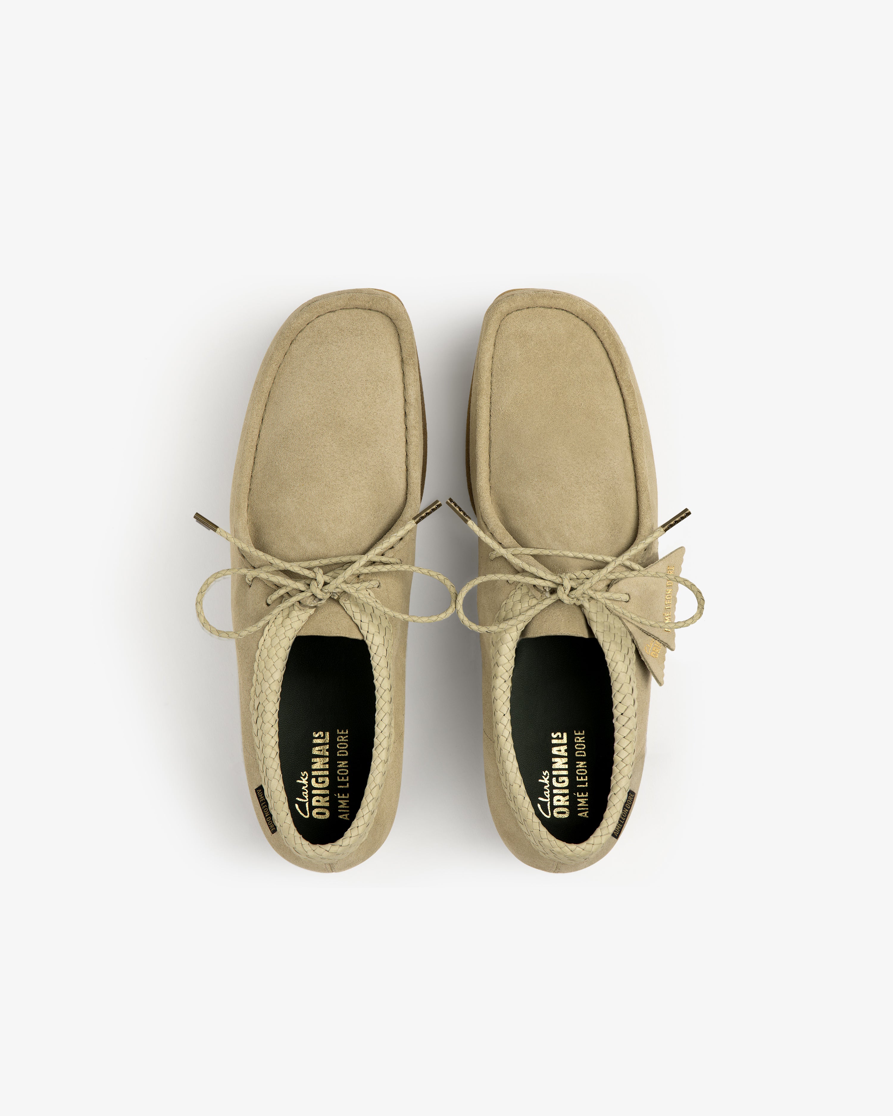 ALD / Clarks Suede Wallabee in tan, seen from above with lace-up detail, visible insoles, and square toe on white.