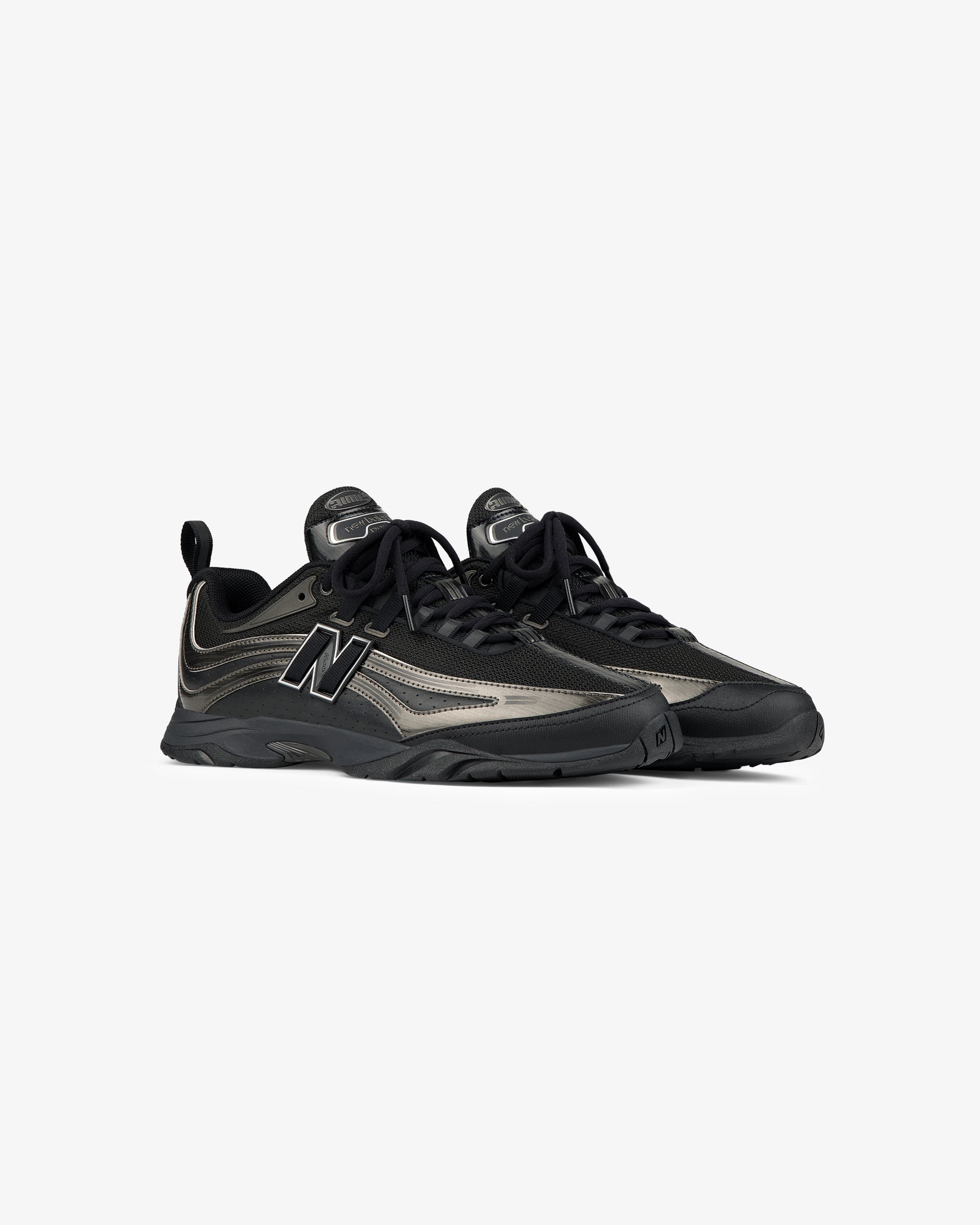 A pair of ALD / New Balance RC56 black and gray lace-up sneakers on a plain white background.