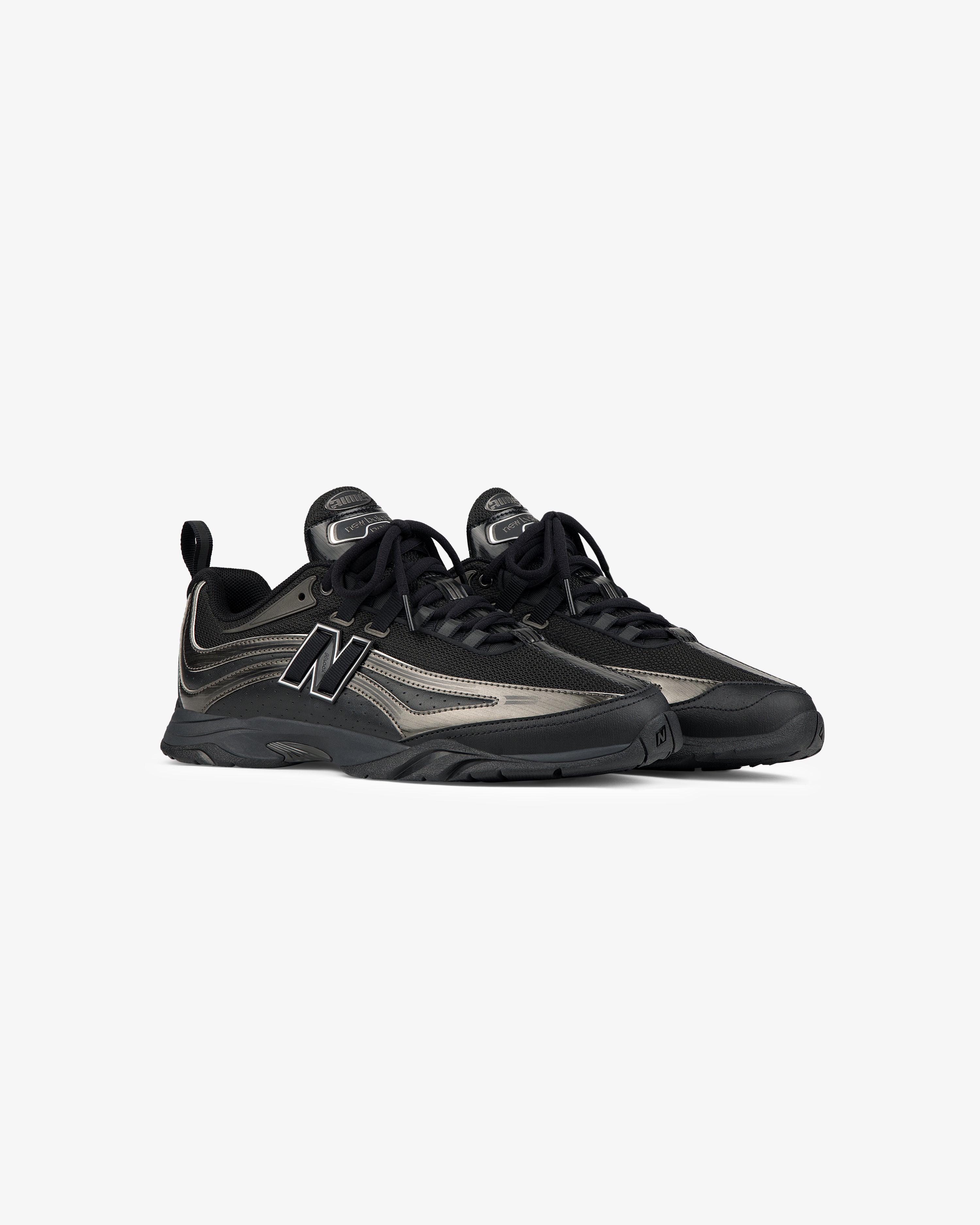 A pair of ALD / New Balance RC56 black and gray lace-up sneakers on a plain white background.