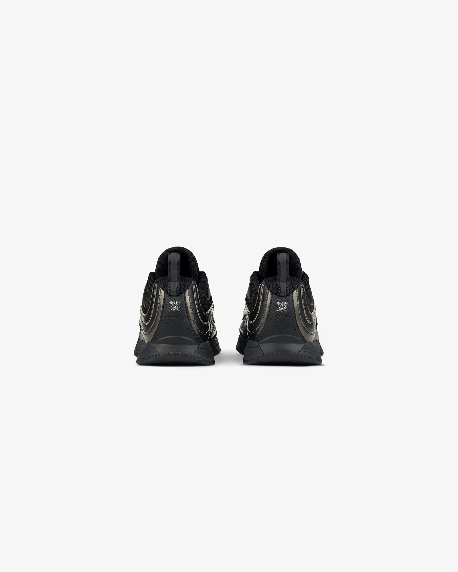 Rear view of ALD / New Balance RC56 black sneakers with metallic gold accents on a plain white background.