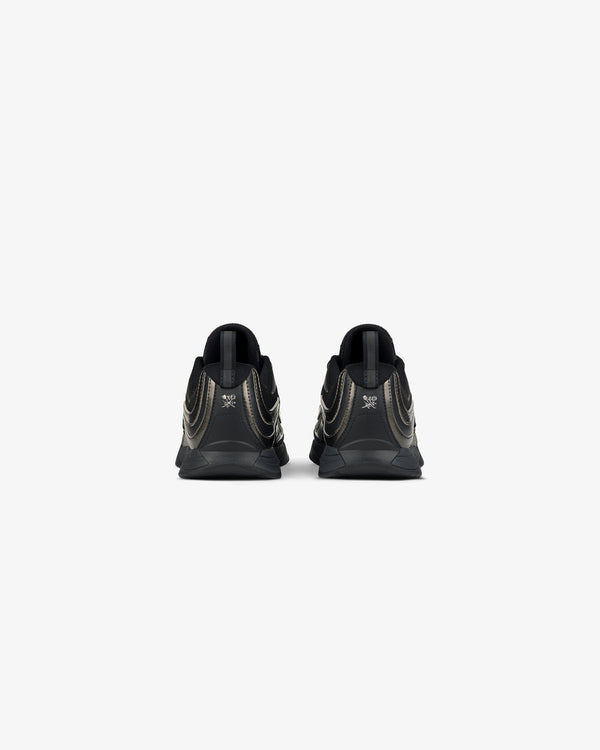 Rear view of ALD / New Balance RC56 black sneakers with metallic gold accents on a plain white background.
