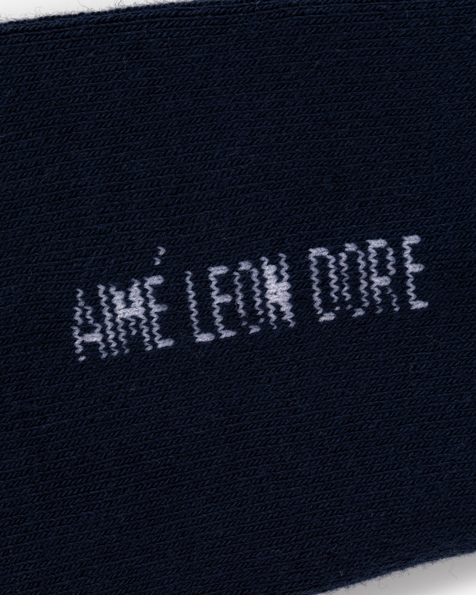 Close-up of navy blue Crew Sock 3-Pack with AIMÉ LEON DORE text stitched in white.