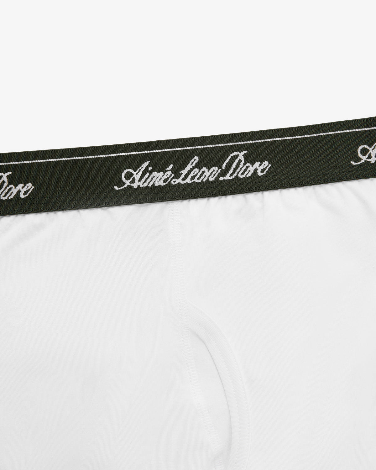 Close-up of Boxer Brief 3-Pack: white underwear with a dark green waistband and Aimé Leon Dore script in white.