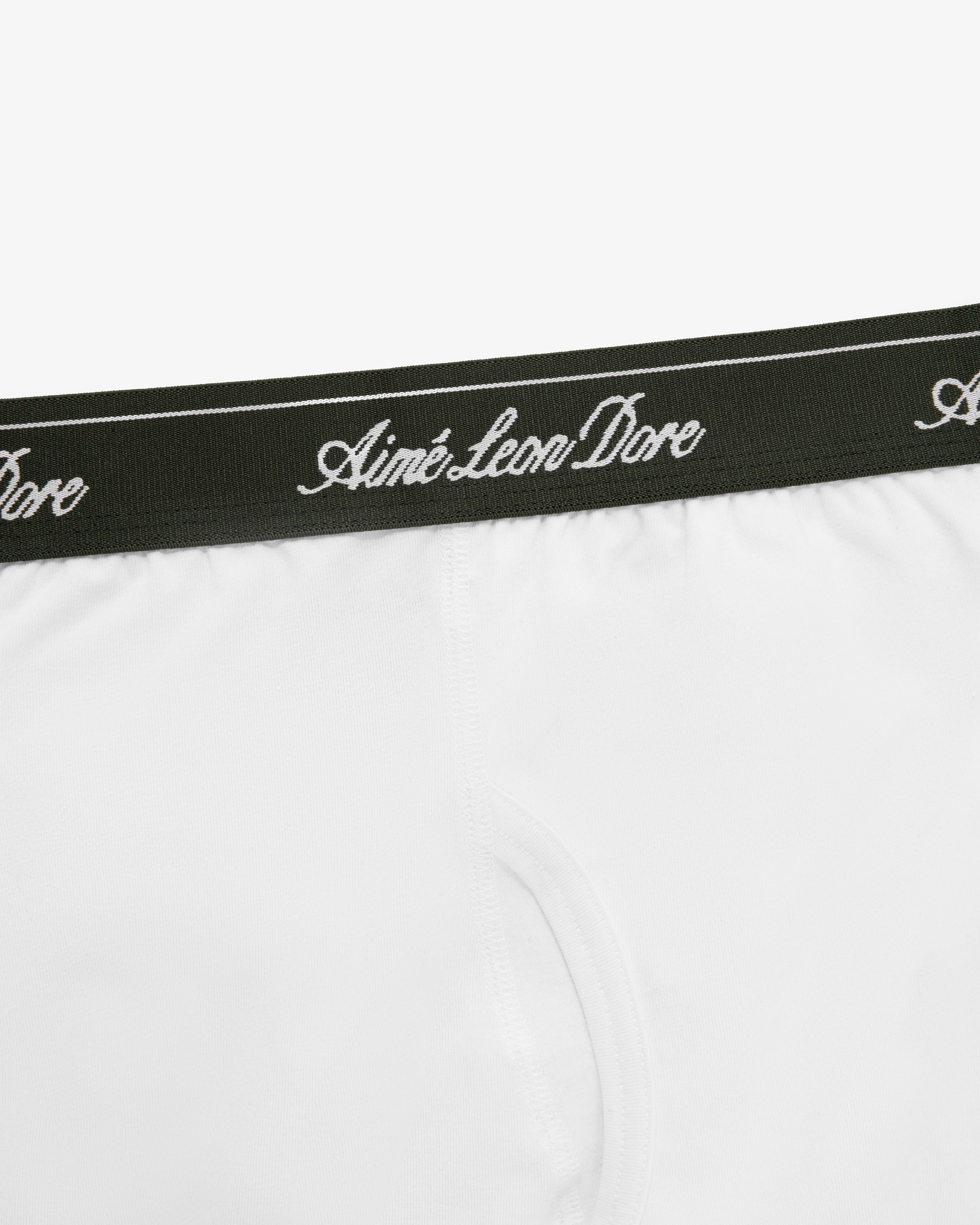 Close-up of Boxer Brief 3-Pack: white underwear with a dark green waistband and Aimé Leon Dore script in white.