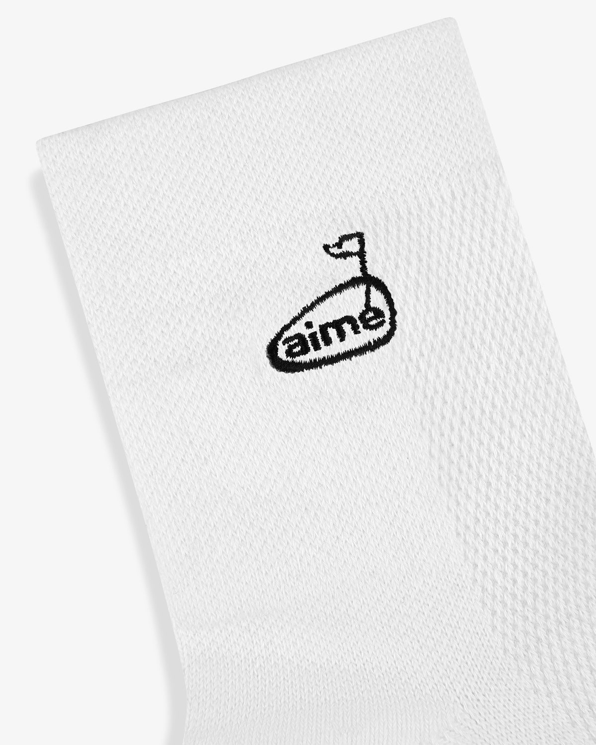 ALD Golf Performance Ankle Sock in white with black golf flag and "aime" embroidered near the top.