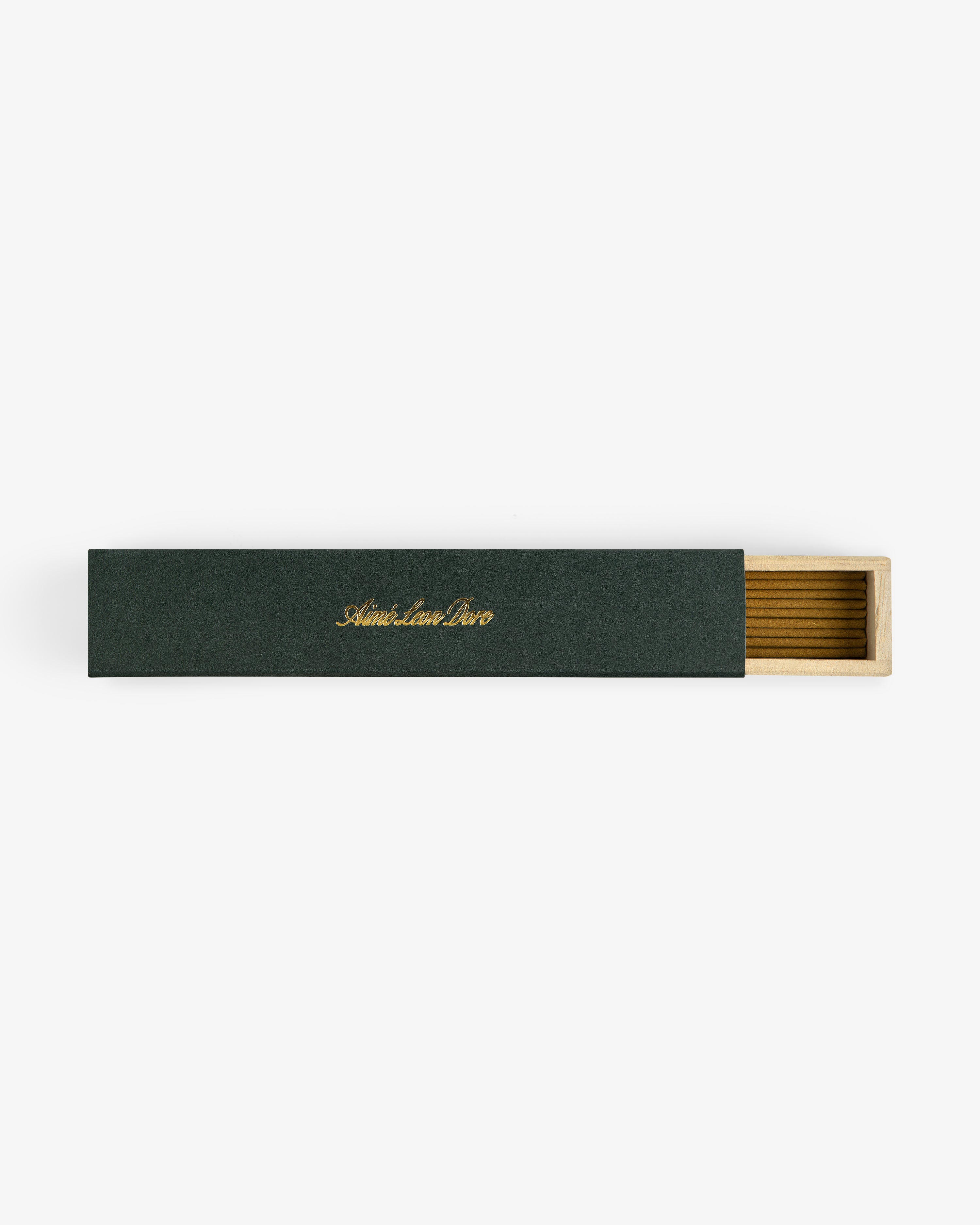 A rectangular green Mulberry Incense box with gold text, partially open to reveal a wooden interior.