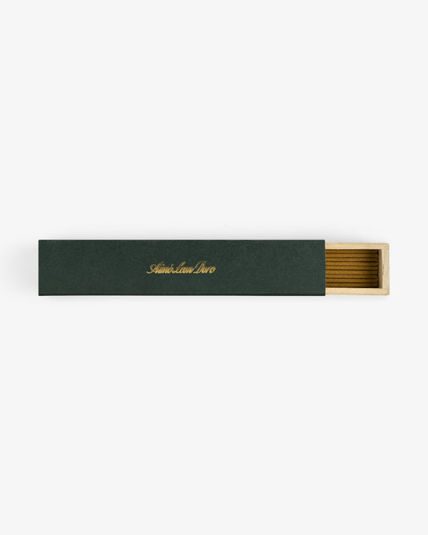 A rectangular green Mulberry Incense box with gold text, partially open to reveal a wooden interior.