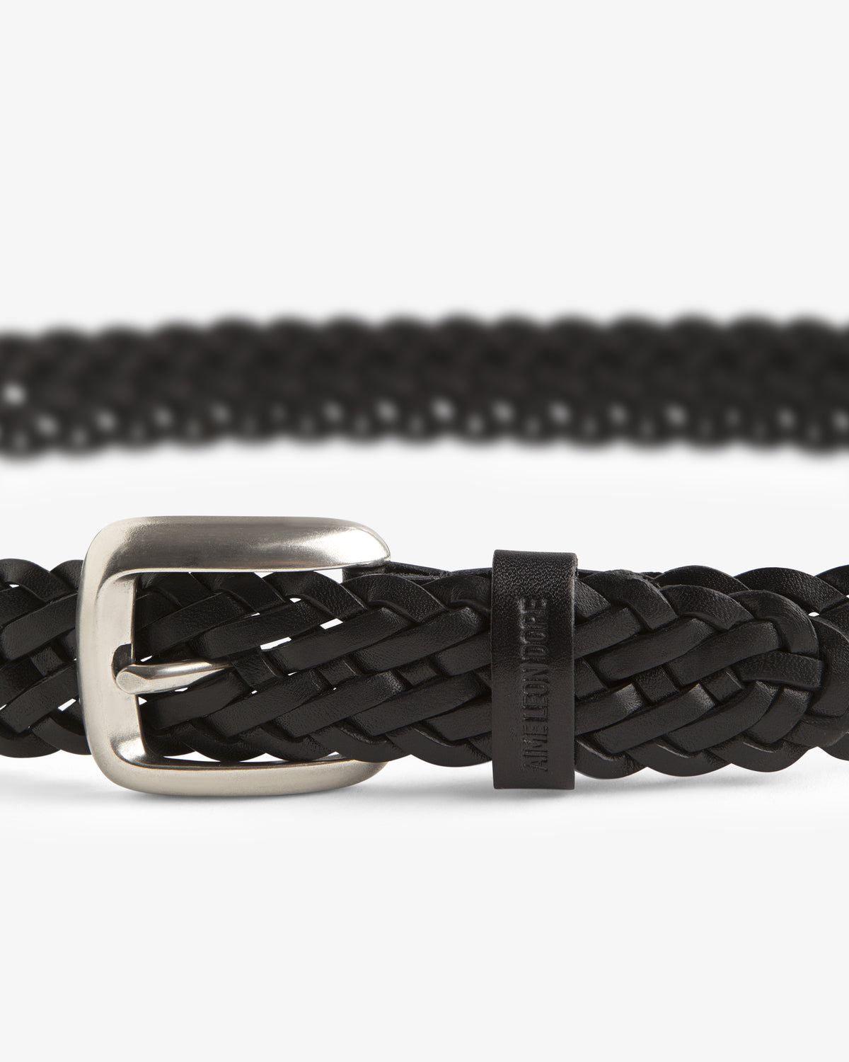 Close-up of the Braided Leather Belt in black with a silver buckle on a white background.