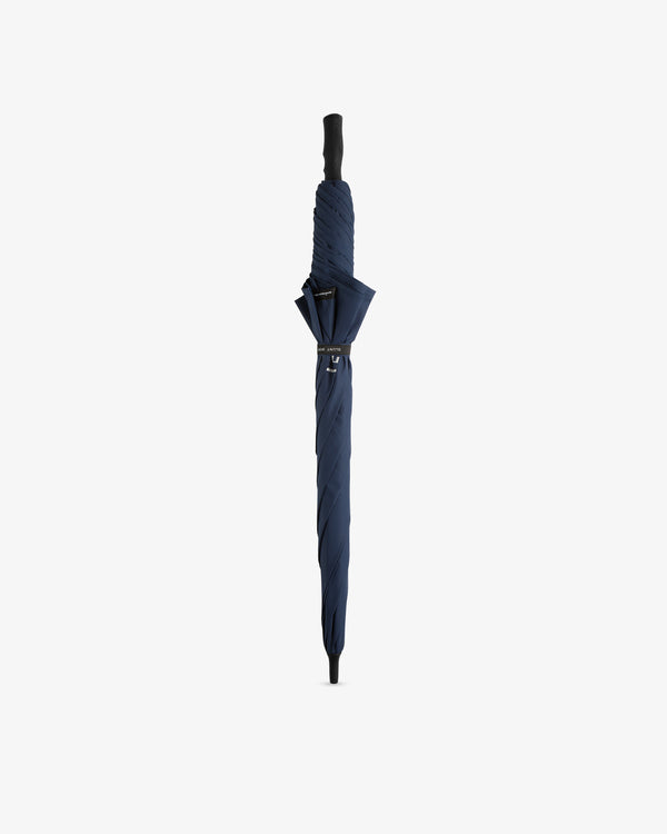 An ALD Golf Spectator Umbrella, closed and navy blue with a black handle, stands upright on a white background.
