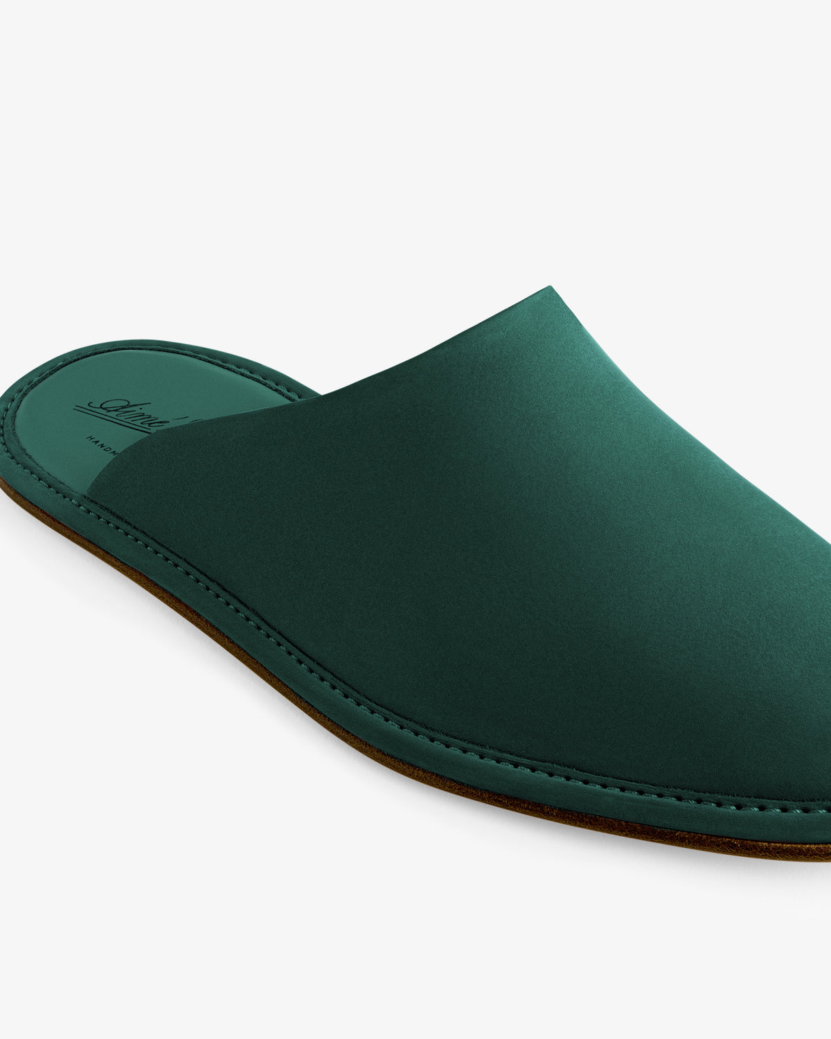 Nubuck Travel Slipper: a green, backless slip-on with a brown sole, displayed on a white background.