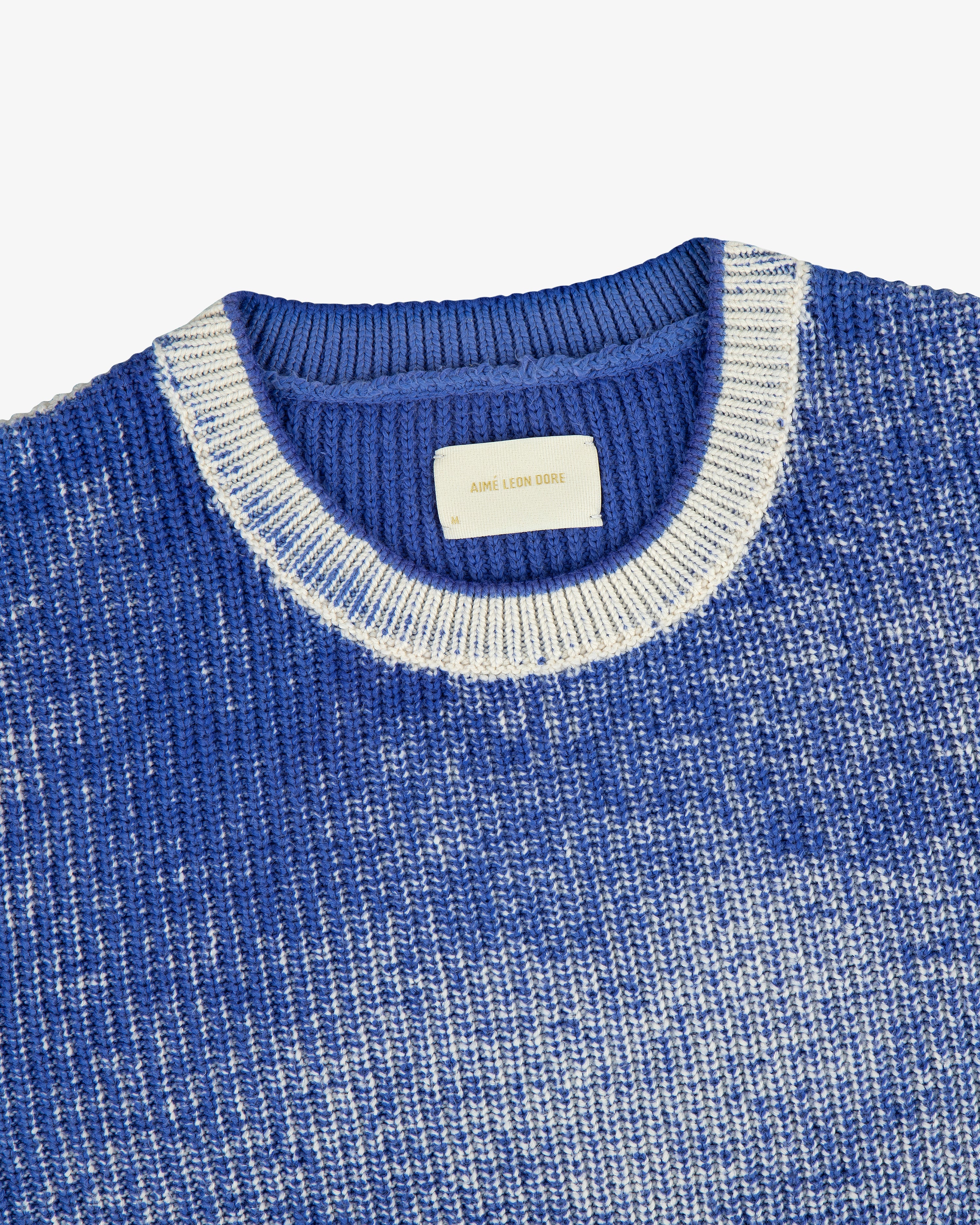 Kalloni Shaker Stitch Sweater in blue and white, features a ribbed collar and visible inner label.