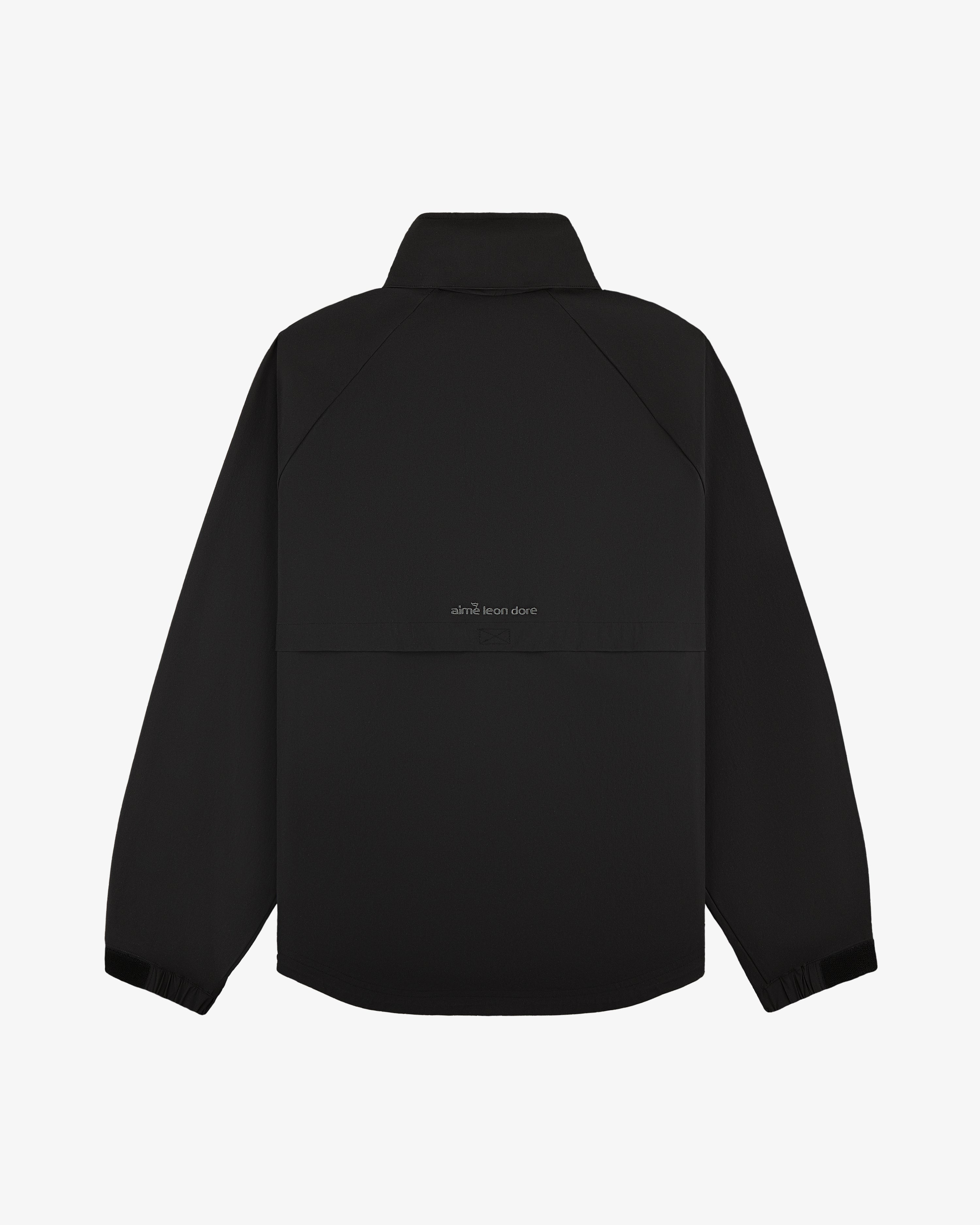 Back of ALD Golf Cordura Tips Jacket: black, long sleeves, collared, with subtle upper-back text.