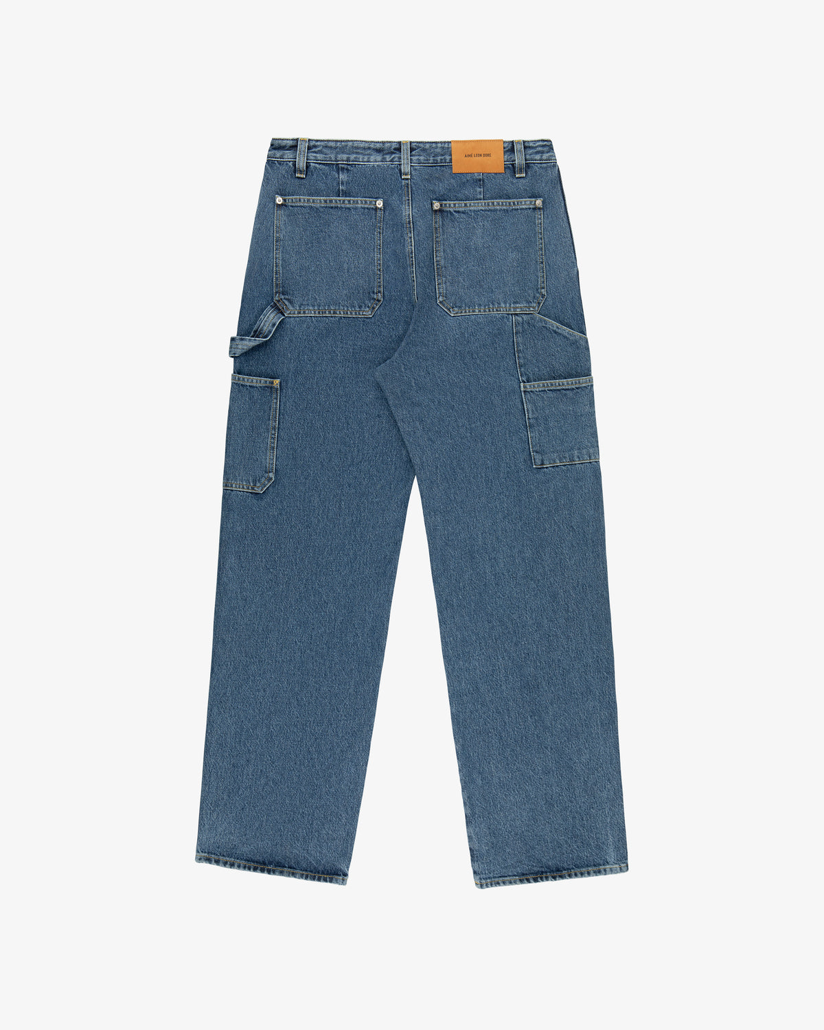 Back view of Denim Carpenter Pant with large pockets, side utility loops, and a brown leather patch on the waistband.