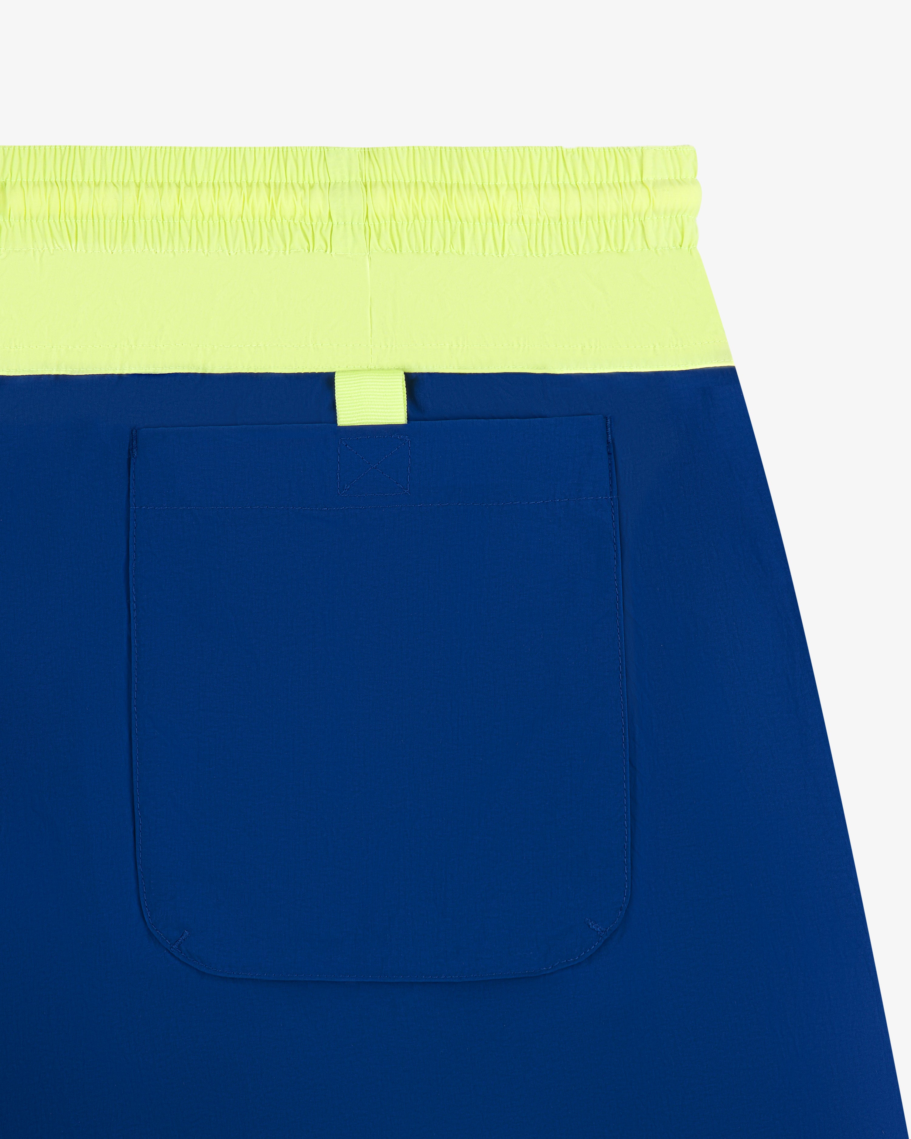 Paneled Sport Short: blue with neon yellow waistband, single large back pocket, shown on a white background.