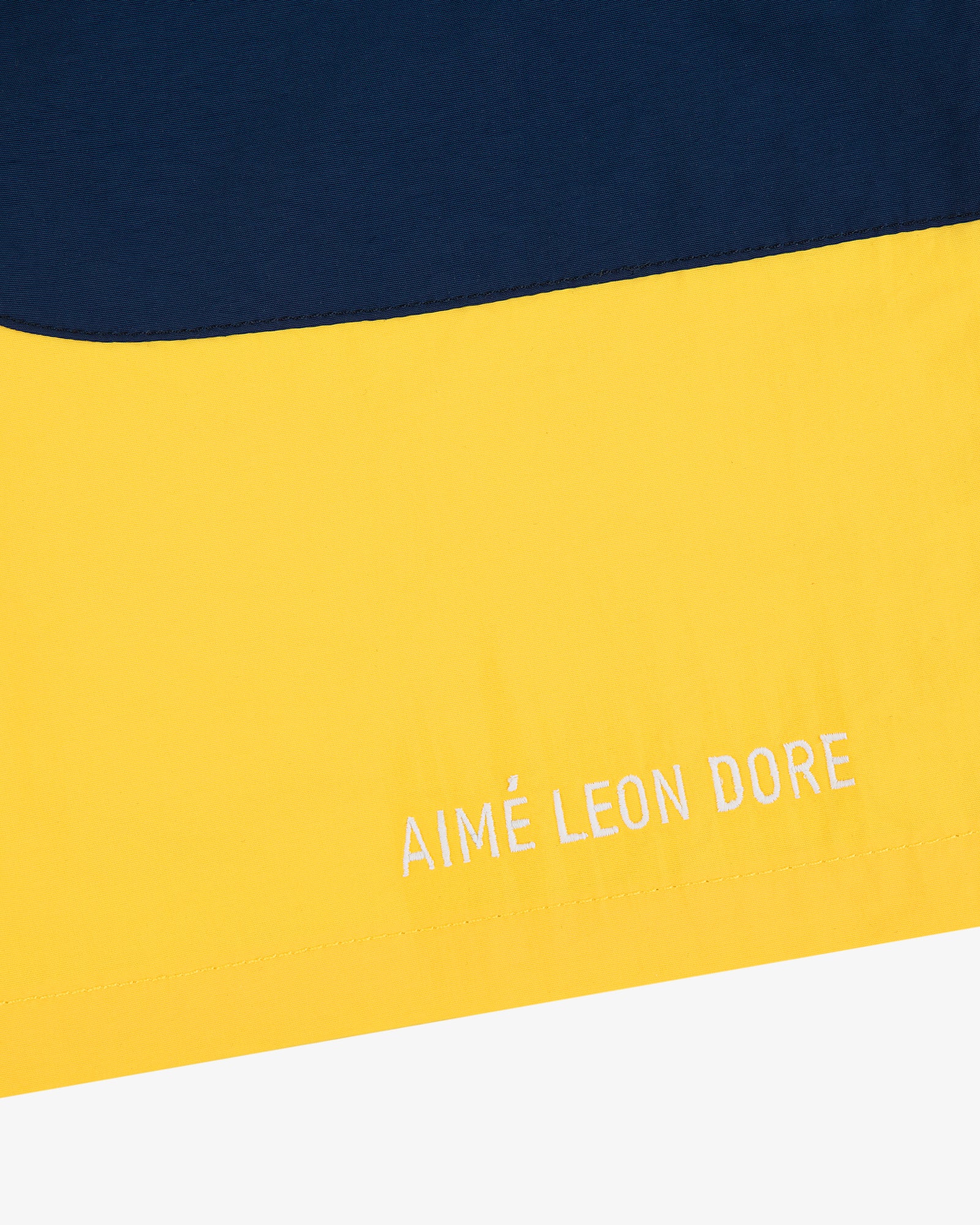 Yellow and navy Offshore Swim Short with AIMÉ LEON DORE embroidered in white on the yellow section.