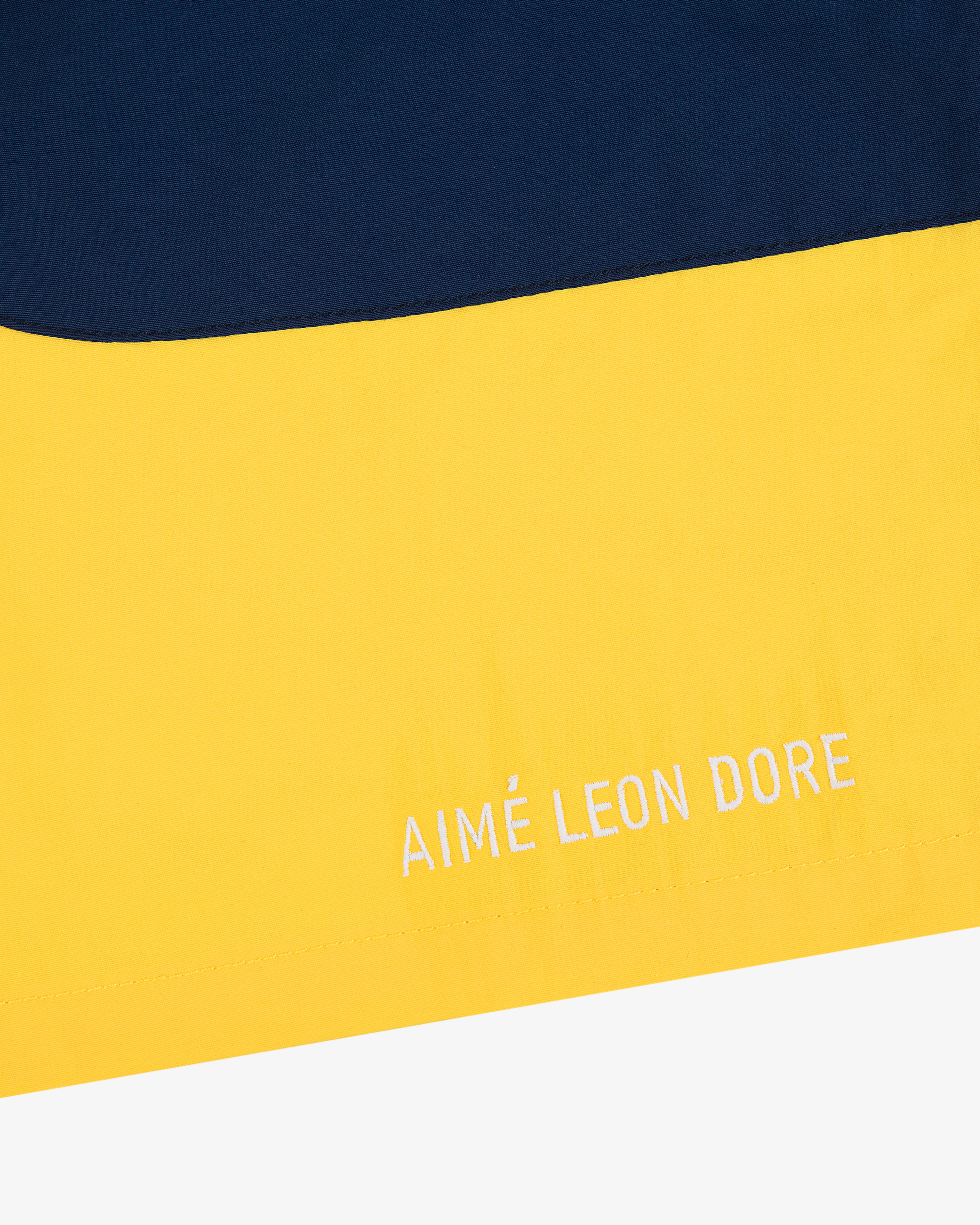 Yellow and navy Offshore Swim Short with AIMÉ LEON DORE embroidered in white on the yellow section.