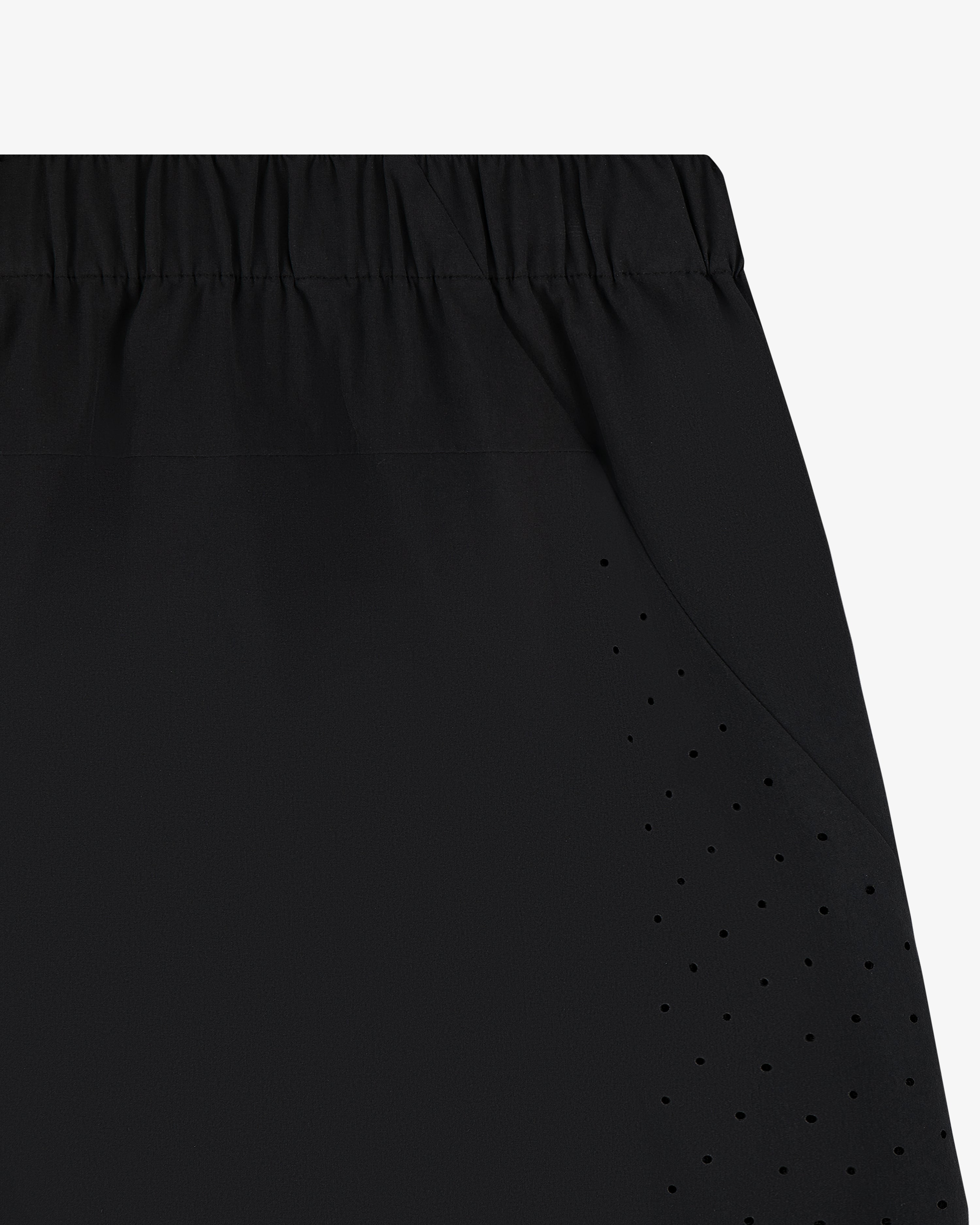Close-up of ALD Golf Performance Short in black with perforated vents and an elastic waistband.