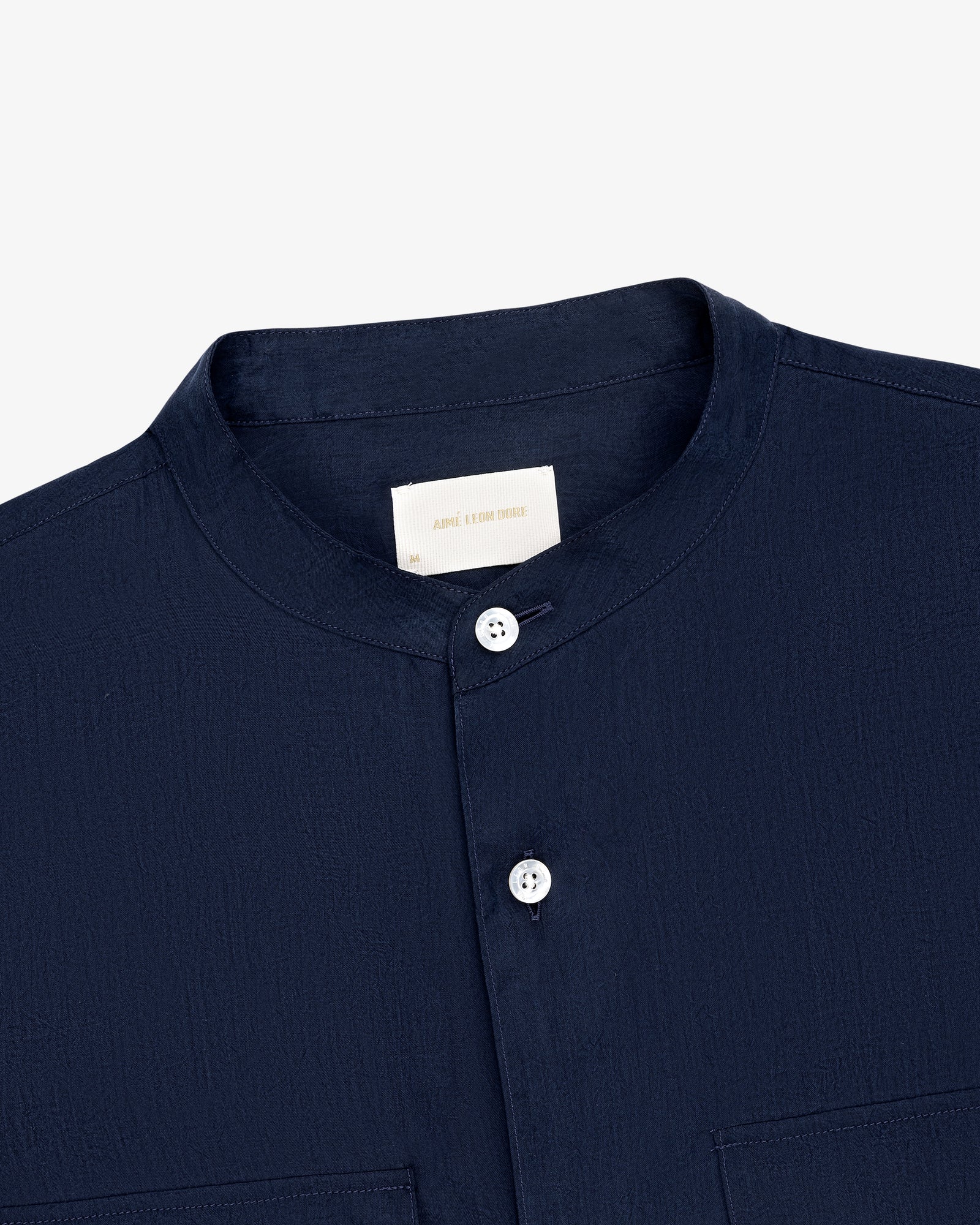 Collarband Safari Shirt in navy blue with white buttons, shown chest-up against a plain white background.