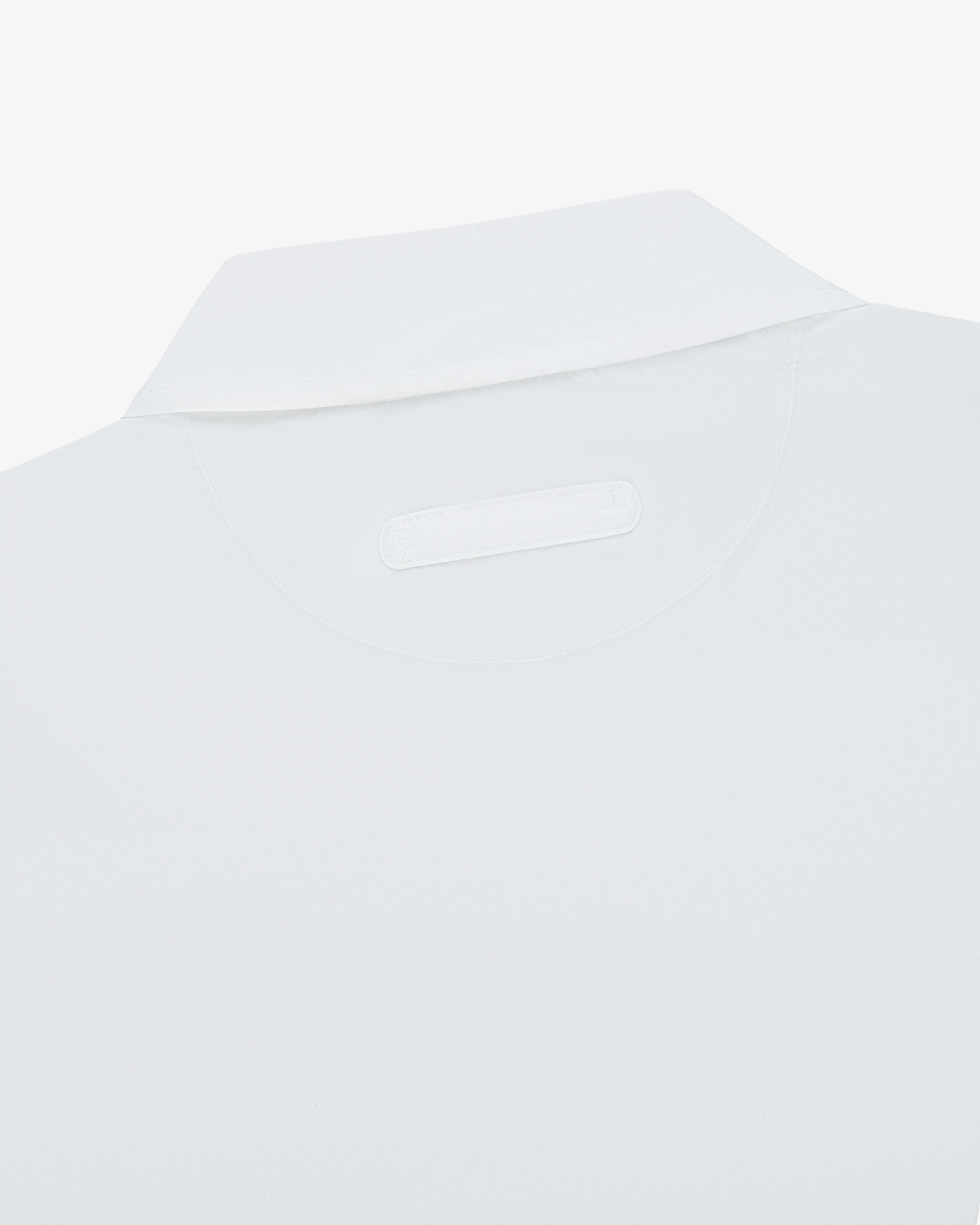 Close-up of the back collar and tag on a white Colorblock Sport Shirt.