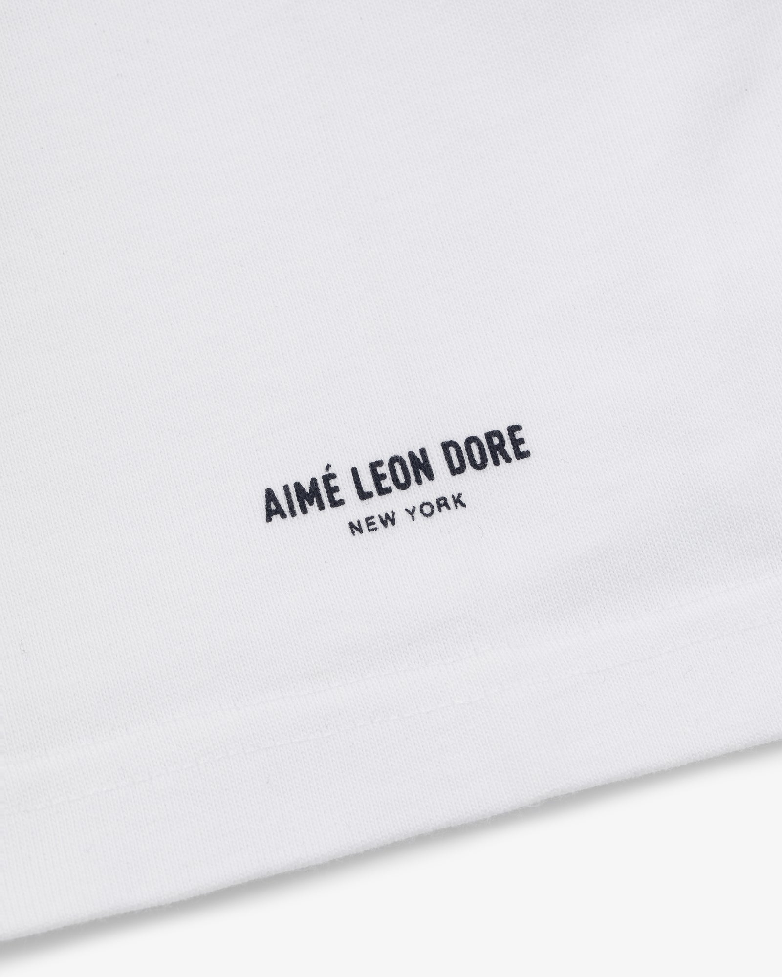 White Yankees Chainstitch Pocket Tee with minimalist AIMÉ LEON DORE NEW YORK text in black near the hem.