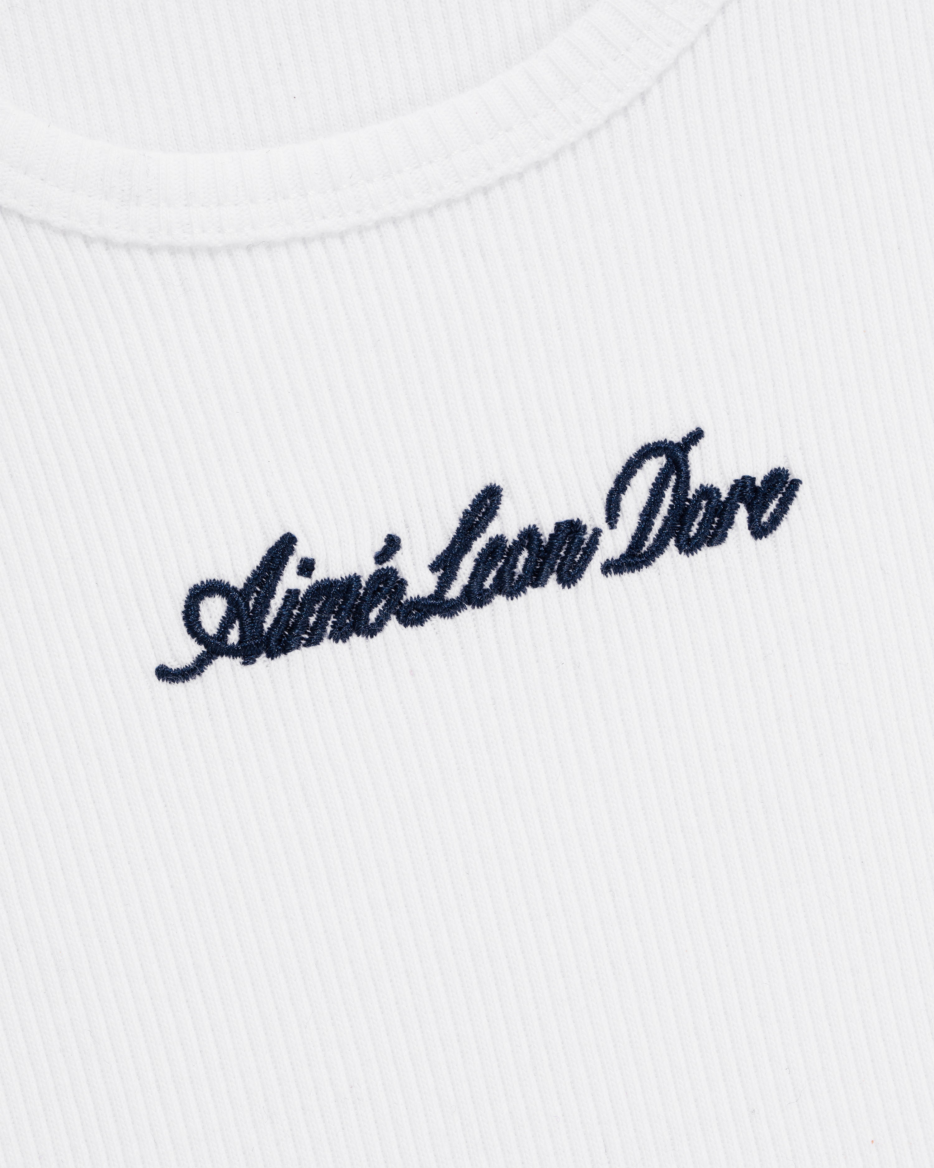 White ribbed Embroidered Logo Tank Top featuring Aimé Leon Dore stitched in black cursive on the chest.