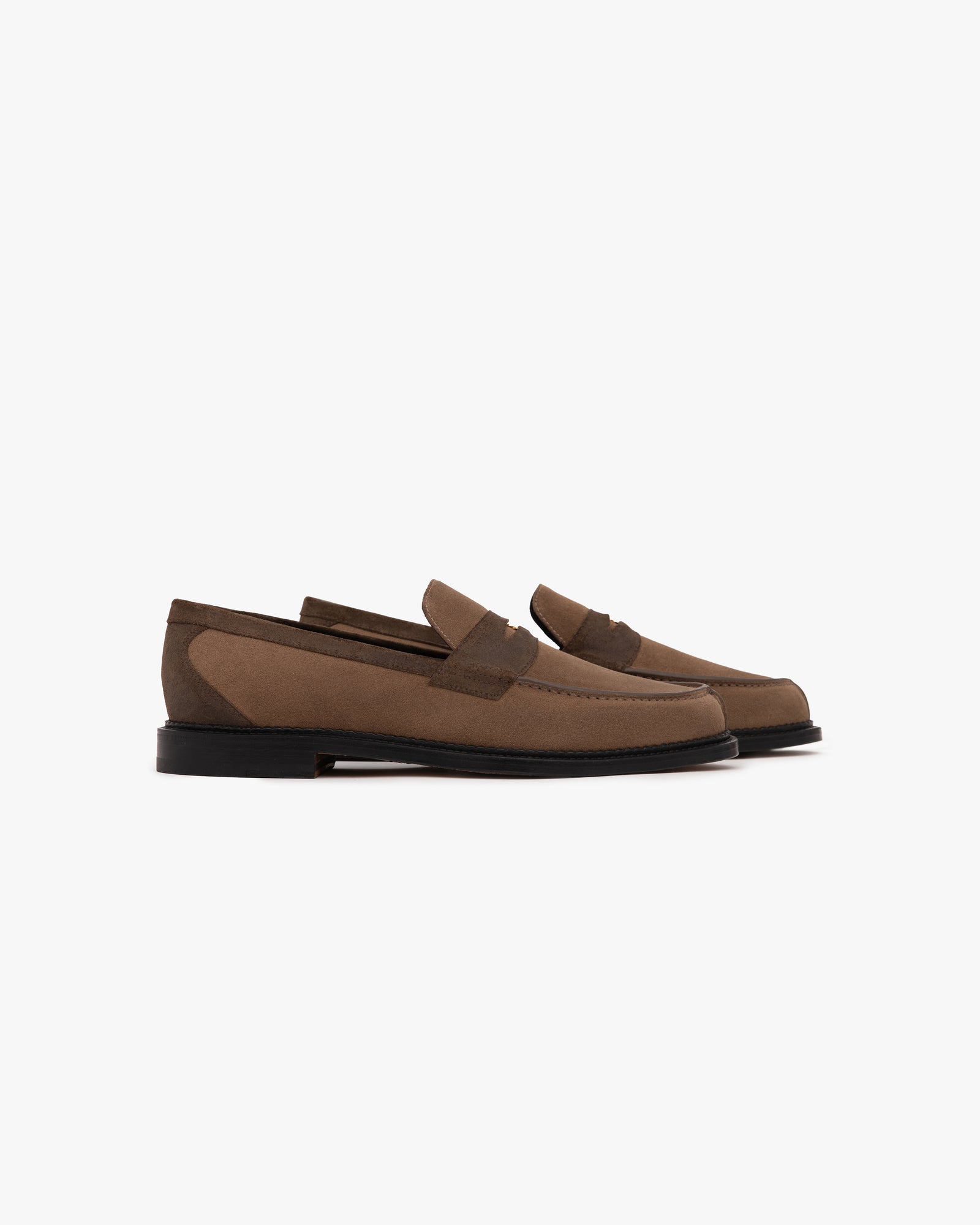 A pair of Suede Queens Crest Loafers with black soles are displayed side by side on a white background.