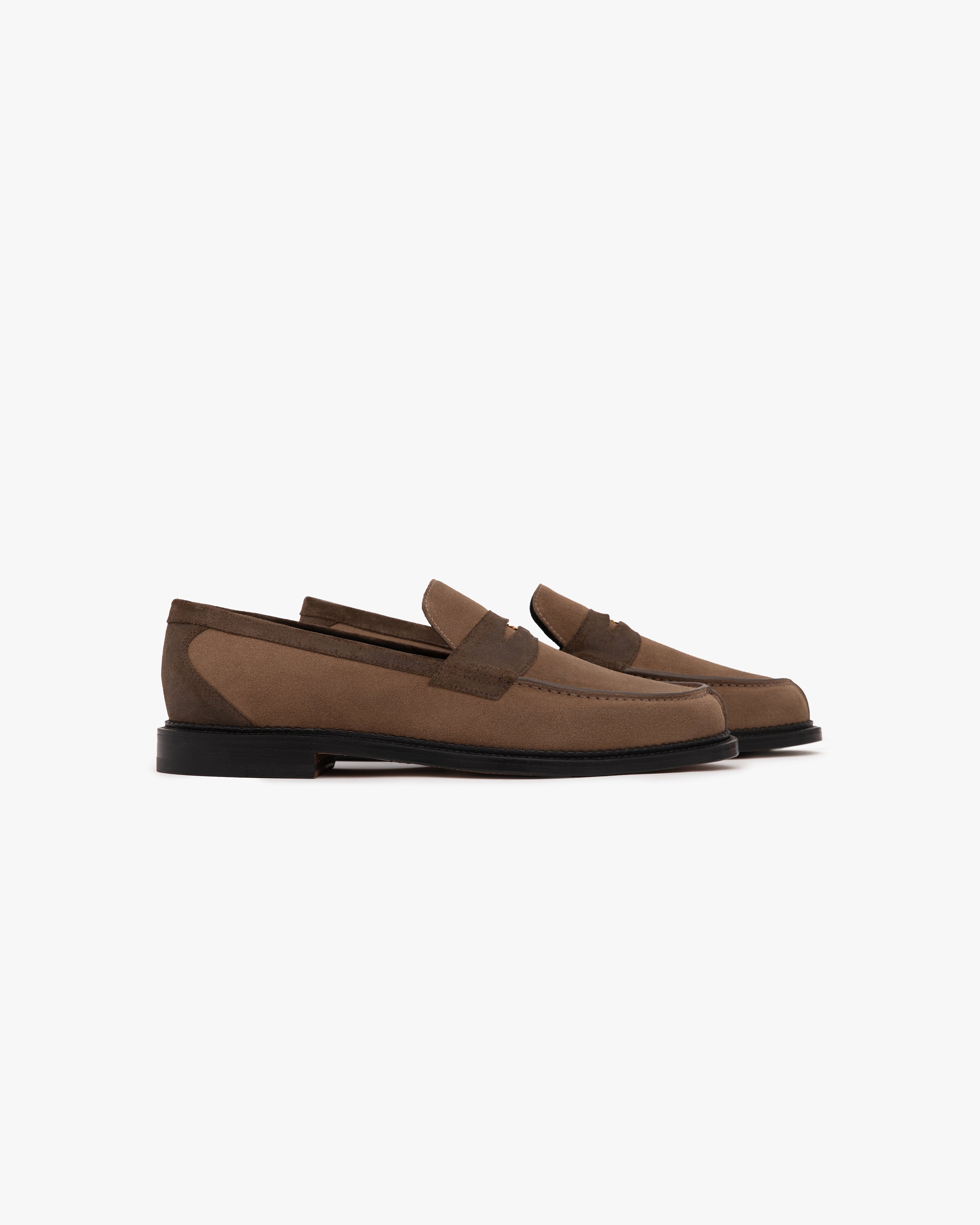 A pair of Suede Queens Crest Loafers with black soles are displayed side by side on a white background.