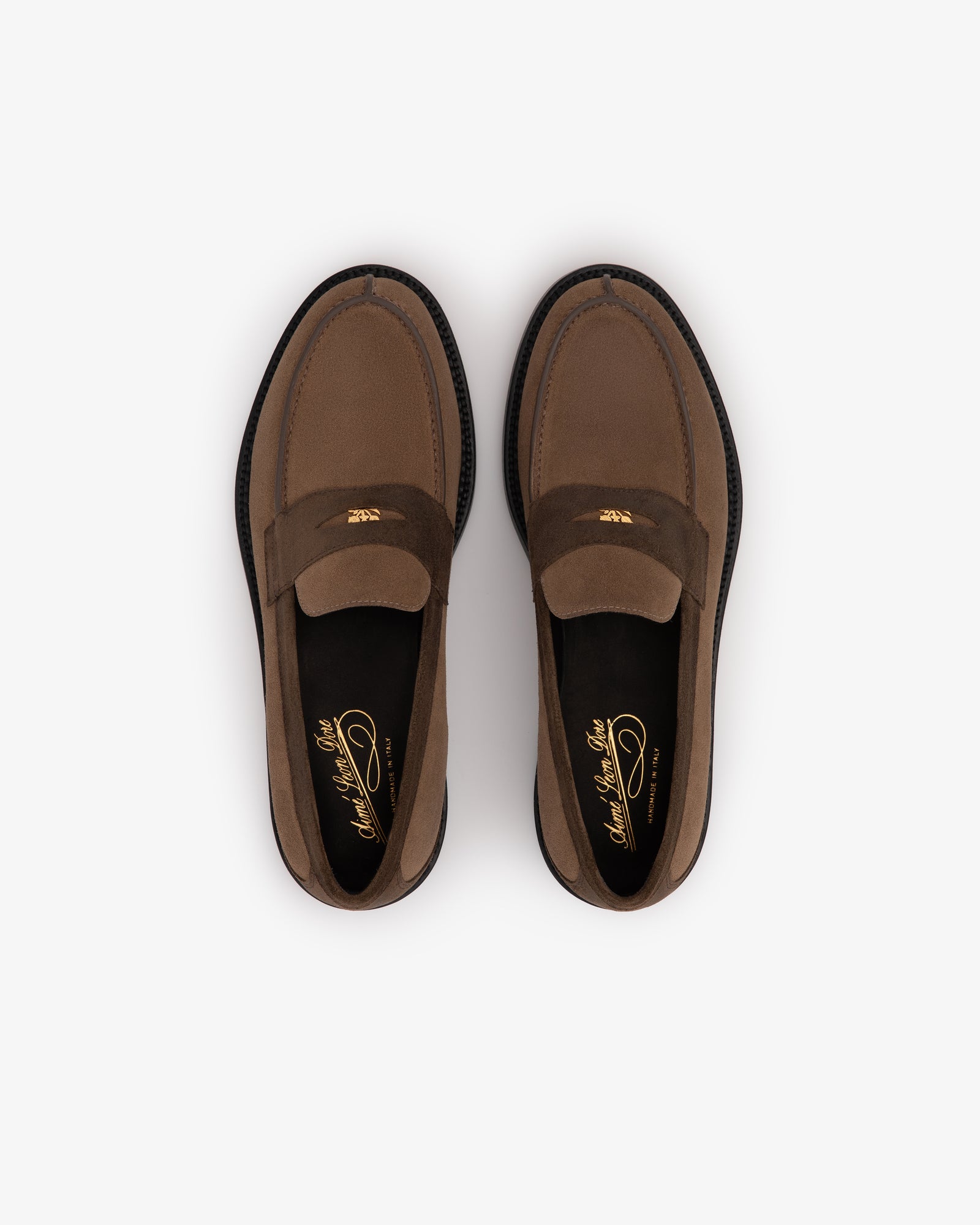 Suede Queens Crest Loafer in brown with black soles, top view, shown on a white background.