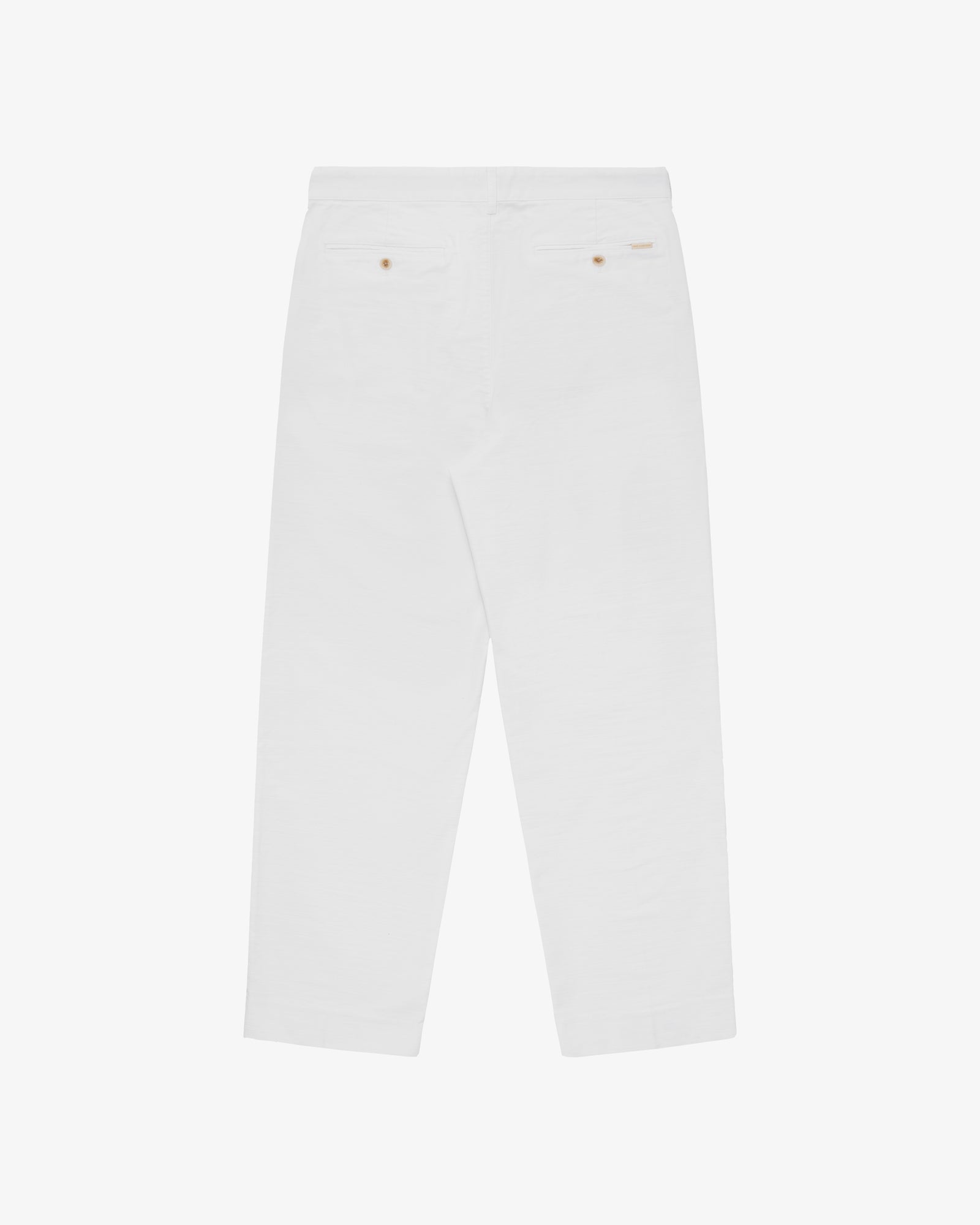 Double Pleated Pant in white, back view with two buttoned welt pockets on a plain background.