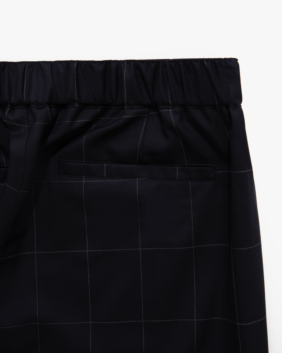 Close-up of Windowpane Elasticated Waist Suit Trouser in black, featuring a subtle plaid pattern and a single back pocket.