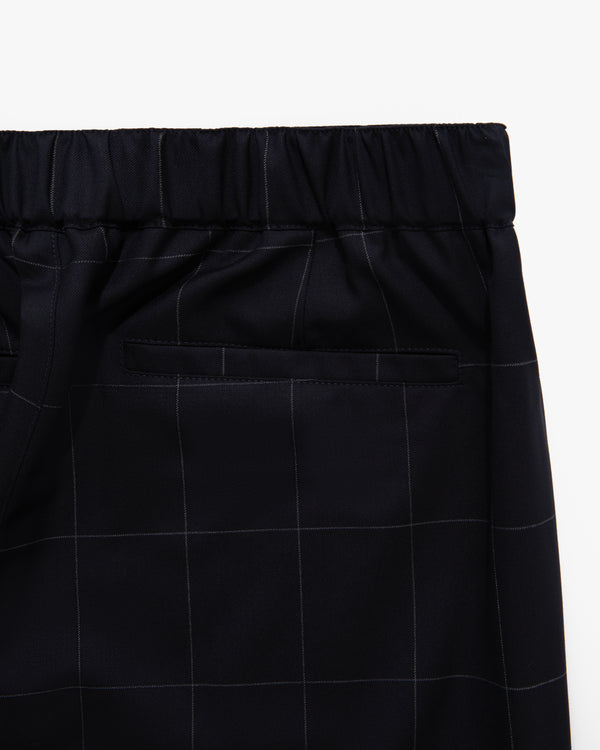 Close-up of Windowpane Elasticated Waist Suit Trouser in black, featuring a subtle plaid pattern and a single back pocket.
