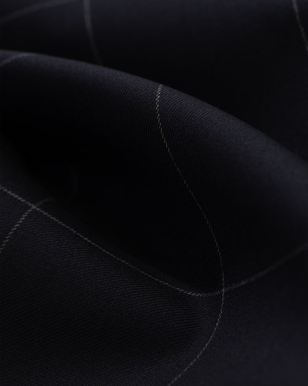 A close-up of the Windowpane Elasticated Waist Suit Trouser shows dark fabric with a subtle light grid and gentle folds.