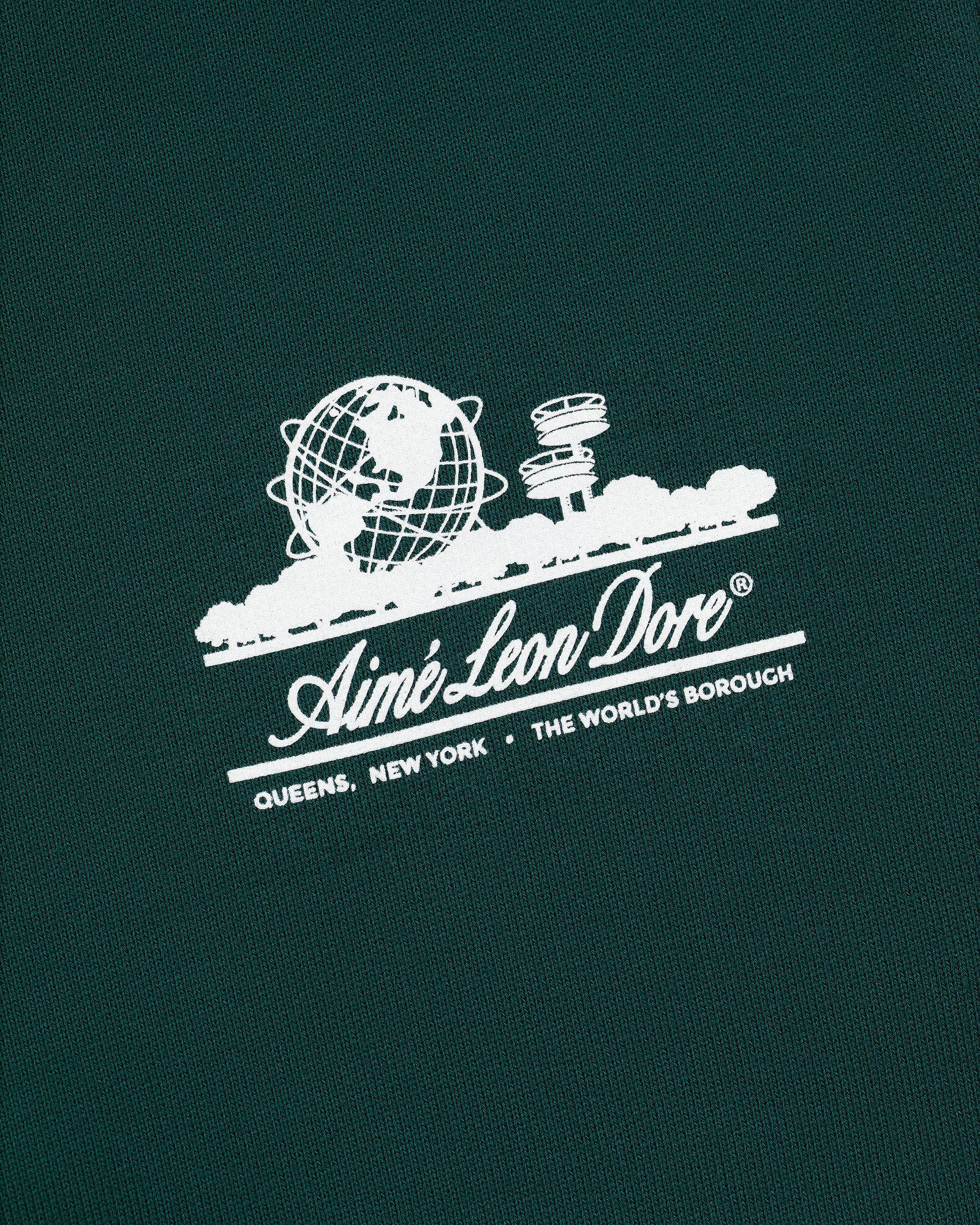 Green Unisphere Sweatpants with white Aimé Leon Dore logo, globe, cityscape, and "QUEENS, NEW YORK - THE WORLDS BOROUGH" text.