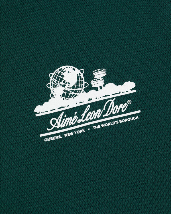 Green Unisphere Sweatpants with white Aimé Leon Dore logo, globe, cityscape, and "QUEENS, NEW YORK - THE WORLDS BOROUGH" text.