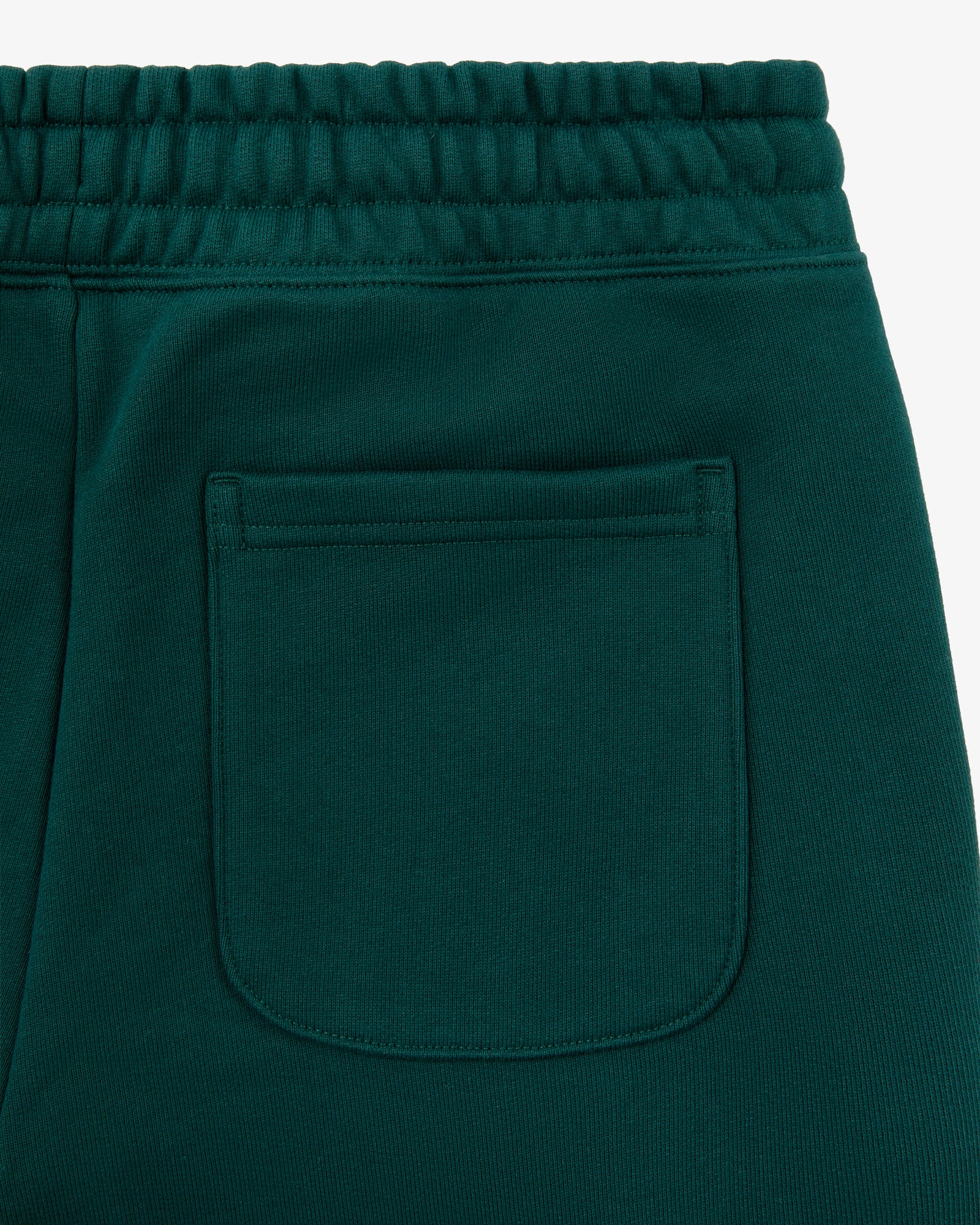 Close-up of the back pocket and waistband of Unisphere Sweatpants in dark green with visible stitching details.