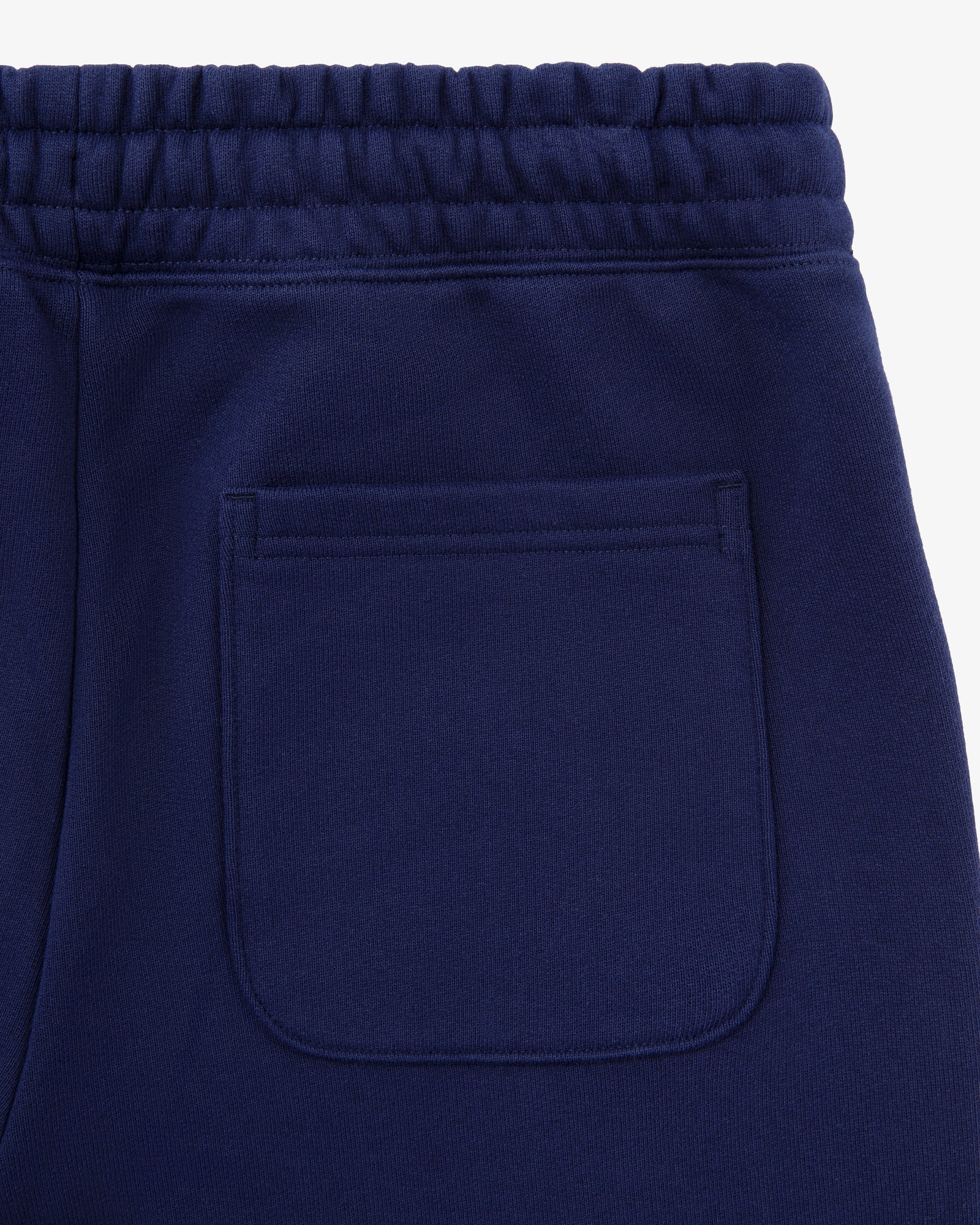 Close-up of Unisphere Sweatpants in navy blue, highlighting the back pocket and elastic waistband.