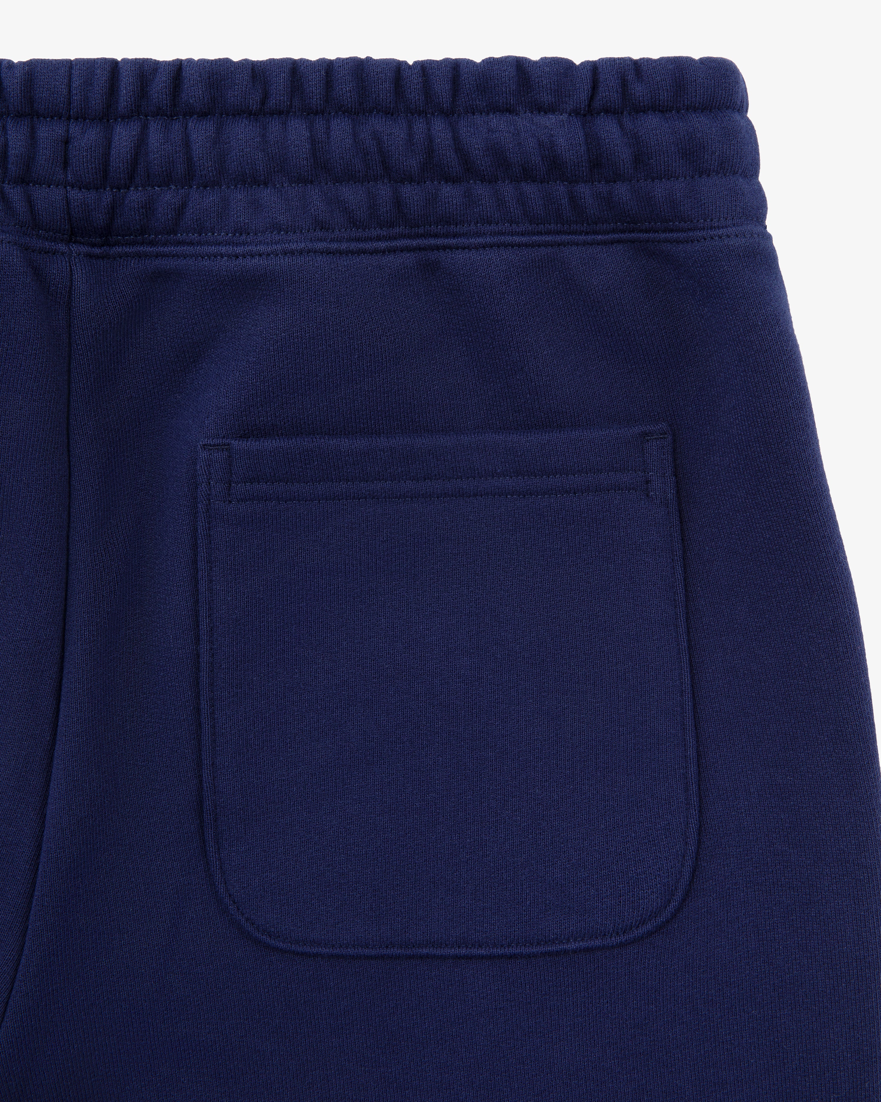 Close-up of Unisphere Sweatpants in navy blue, highlighting the back pocket and elastic waistband.