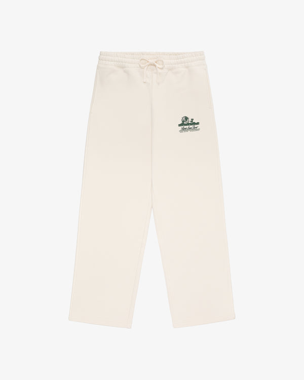 Unisphere Sweatpants in cream with a drawstring waist and small green graphic and text on the left hip.