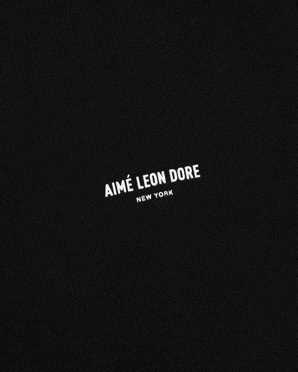 Black fabric sweatpants with small white AIMÉ LEON DORE NEW YORK logo centered on the front.