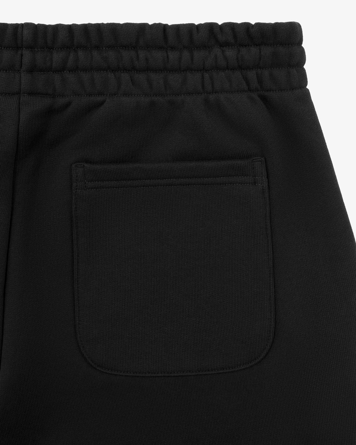 Close-up of Tonal Logo Sweatpants in black with an elastic waistband and a single rear patch pocket.