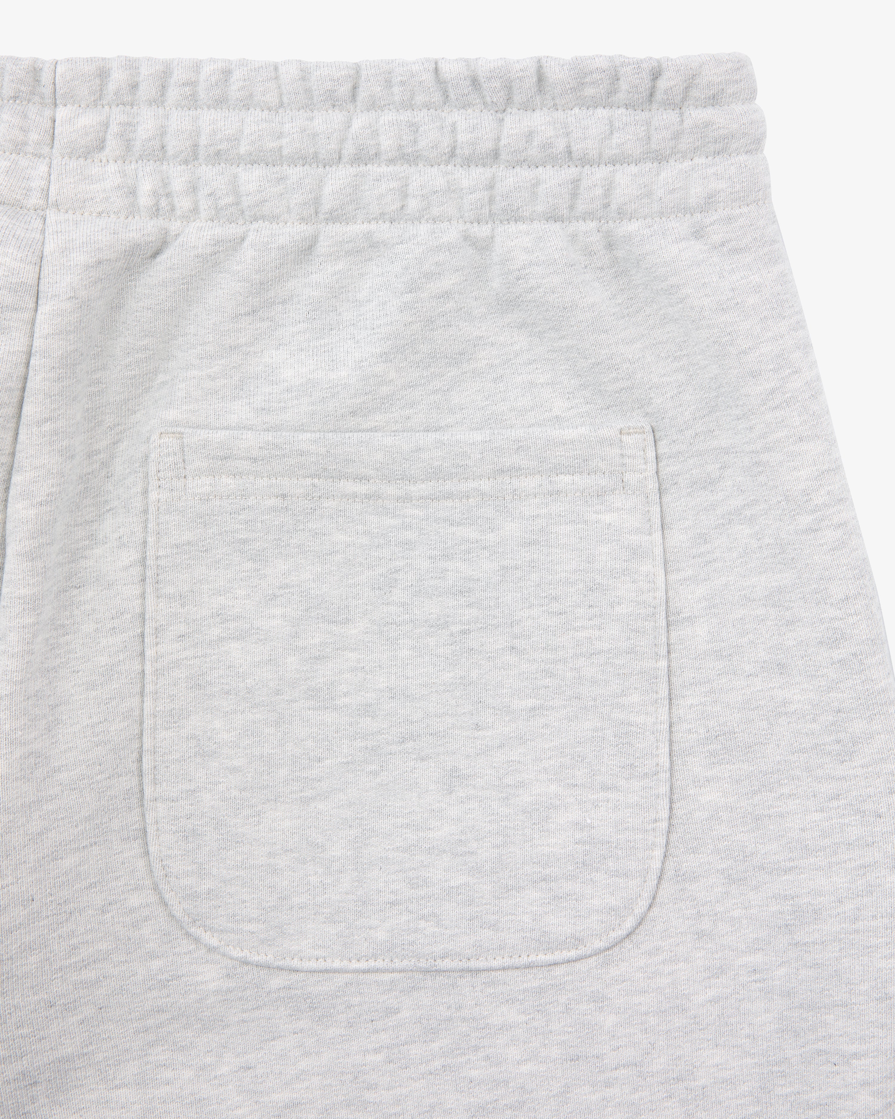 Close-up of the back pocket and waistband on Micro Logo Sweatpants in light gray with an elastic waist.