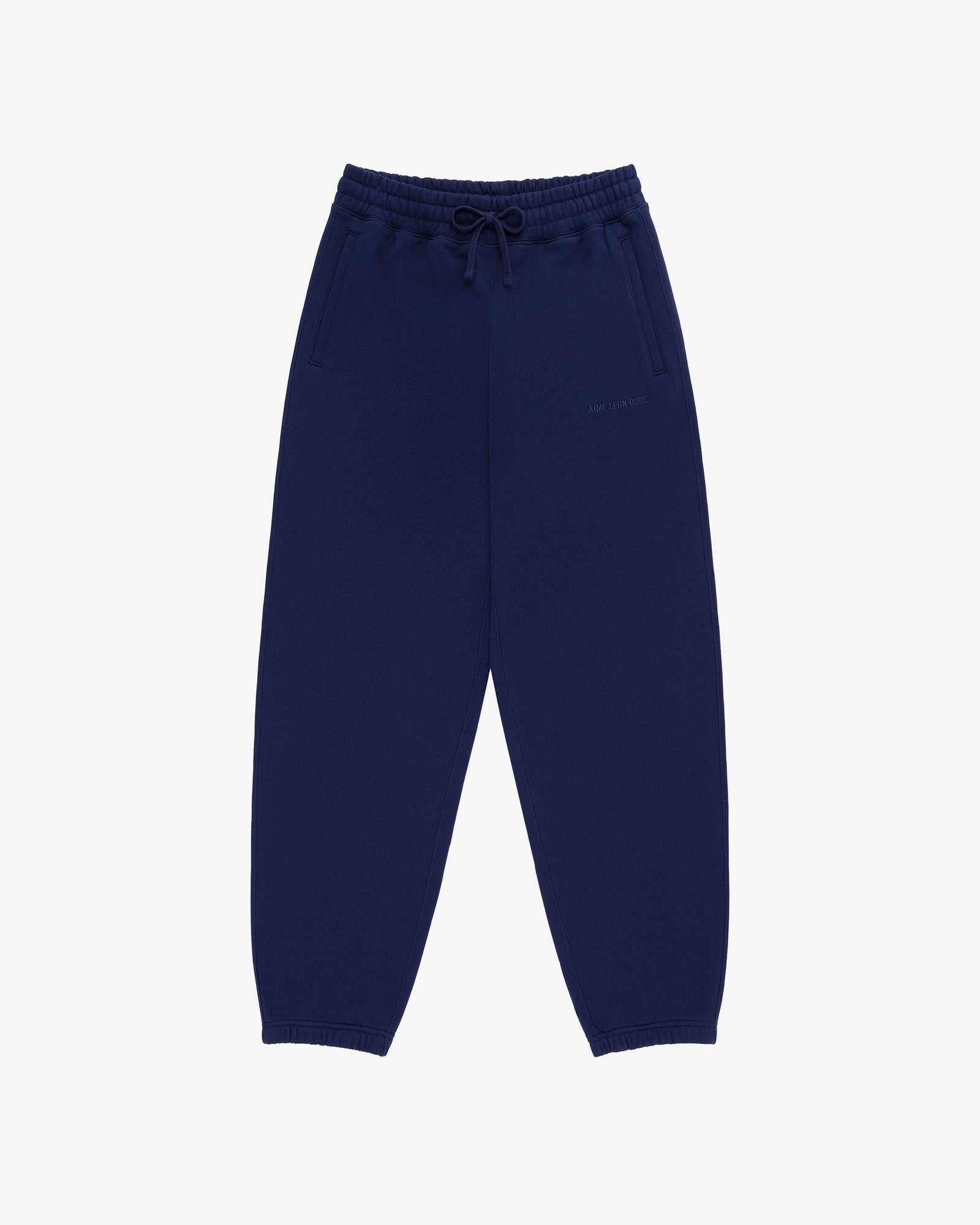 Tonal Logo Sweatpants in navy blue with elastic waistband, drawstring, side pockets, and elastic cuffs on white background.