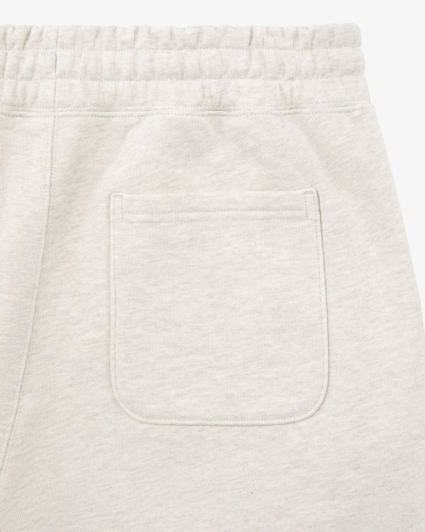 Close-up of the back pocket and elastic waistband on Tonal Logo Sweatpants in light beige.