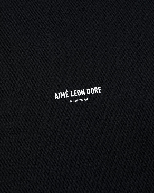 Black Micro Logo Crewneck Sweatshirt with small white AIMÉ LEON DORE NEW YORK text centered on front.