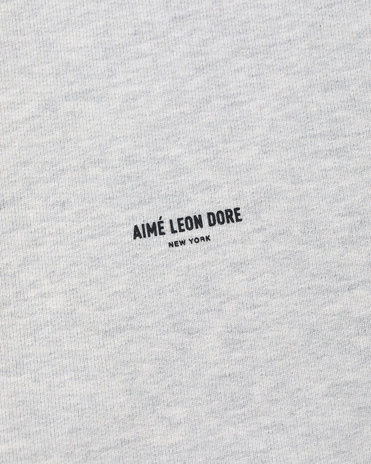 Gray Micro Logo Hoodie with small black "AIMÉ LEON DORE NEW YORK" text centered on the fabric.