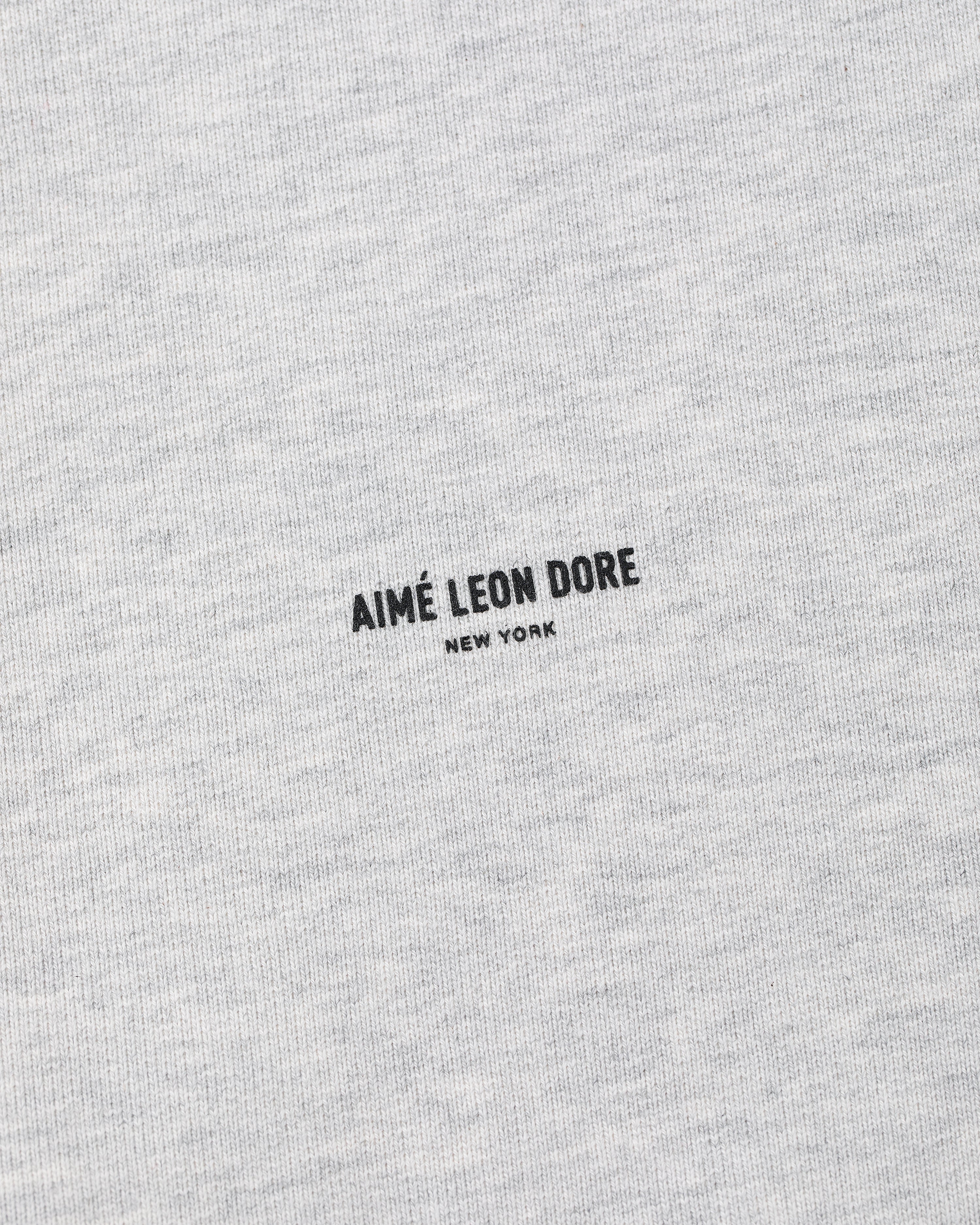 Close-up of a gray Micro Logo Crewneck Sweatshirt with AIMÉ LEON DORE NEW YORK printed in black at the center.